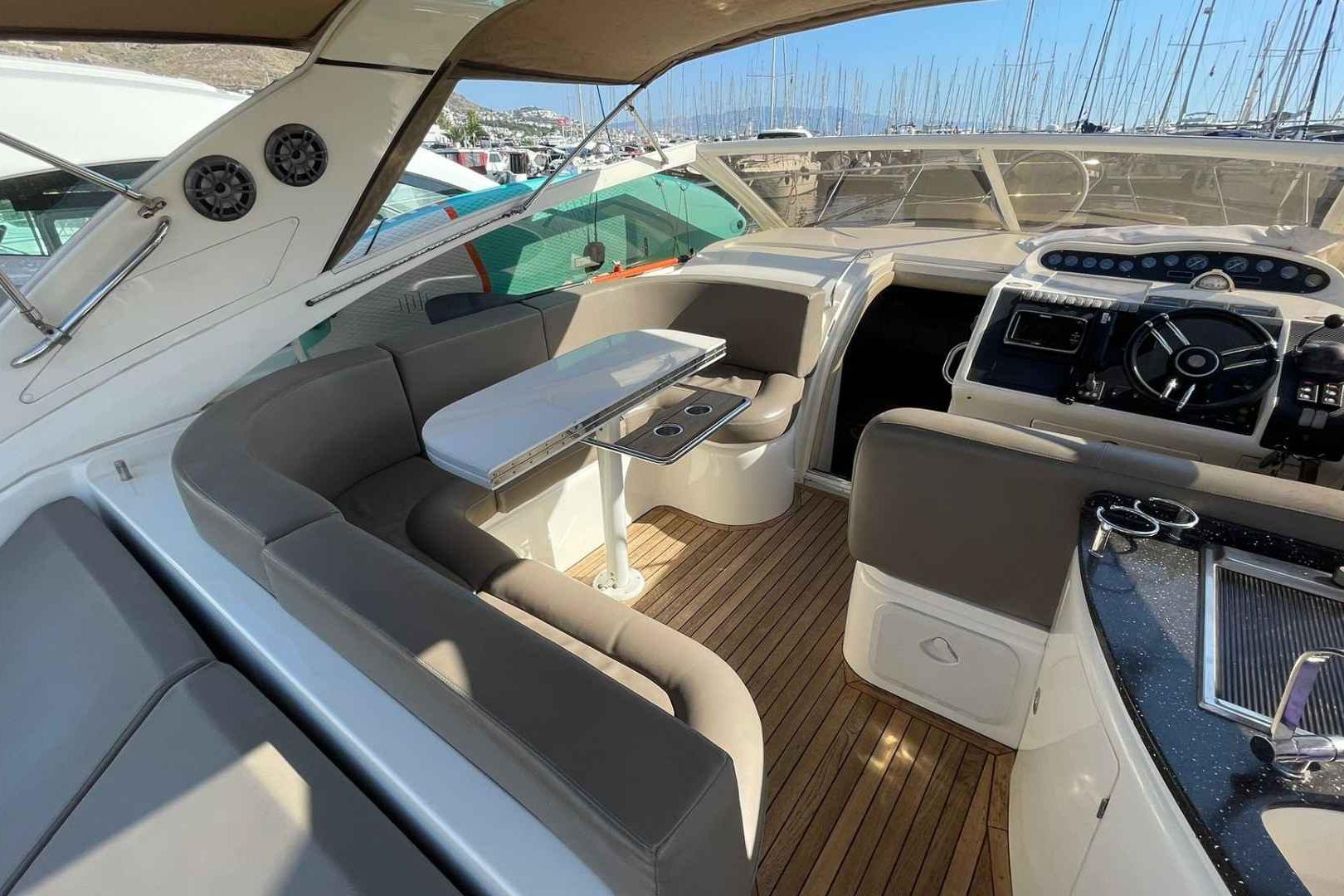 Luxurious interior of a 2000 Princess V42 yacht with elegant seating and modern helm.