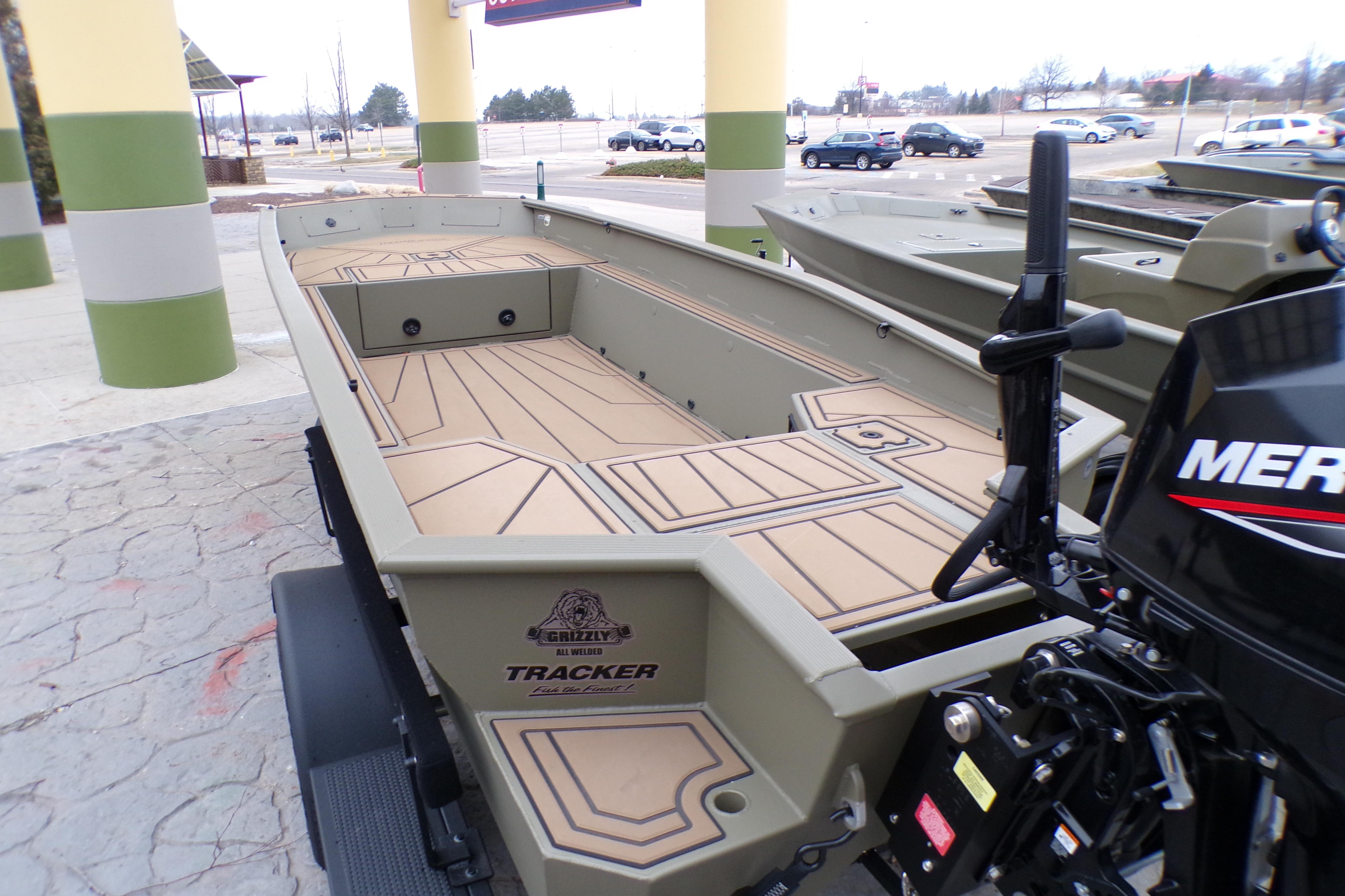2026 Tracker Grizzly 1650 T Prairie Wings Edition boat with Mercury motor, parked outdoors.