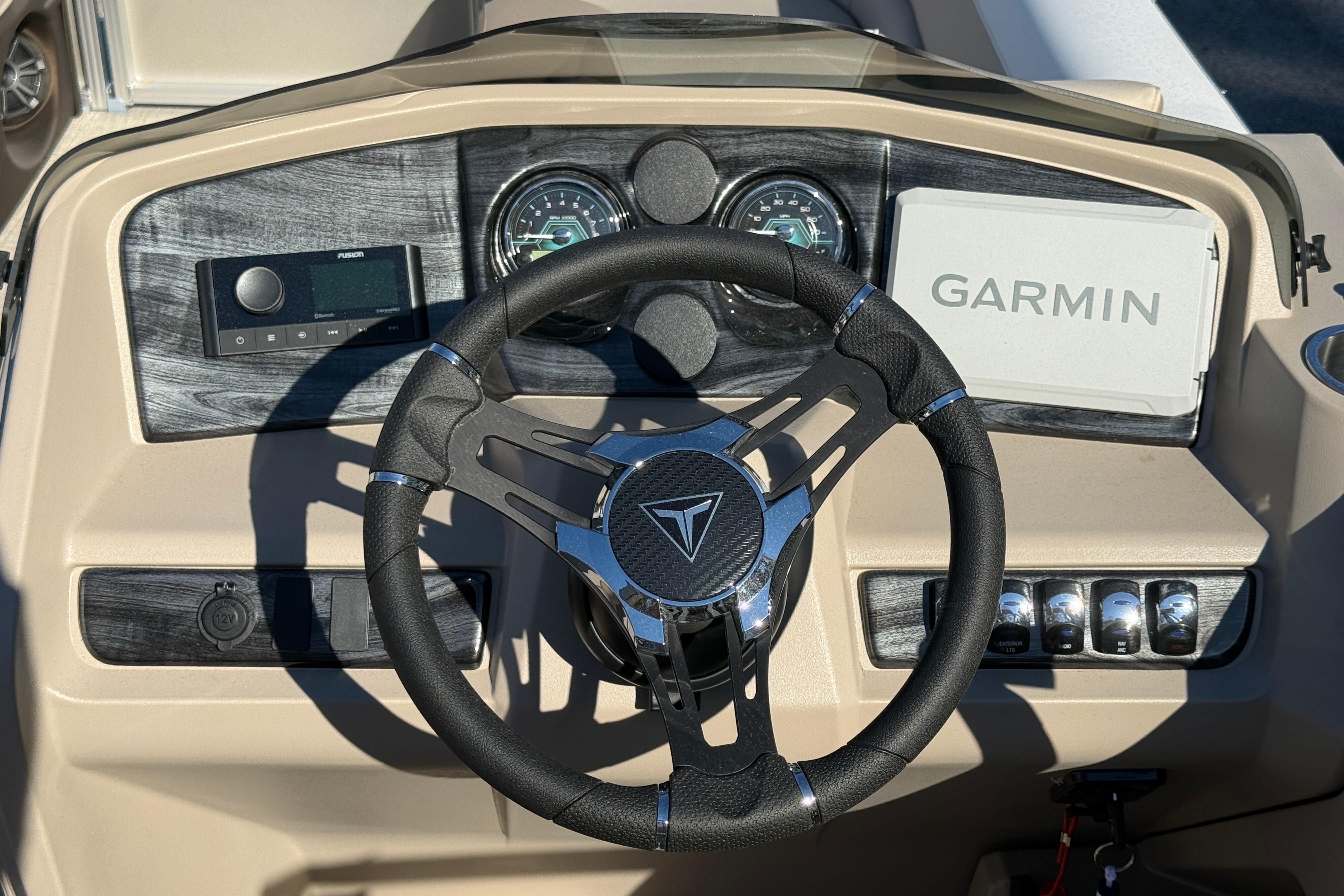 2026 Tahoe Pontoon LTZ Versatile Rear Lounger dashboard with Garmin navigation system.
