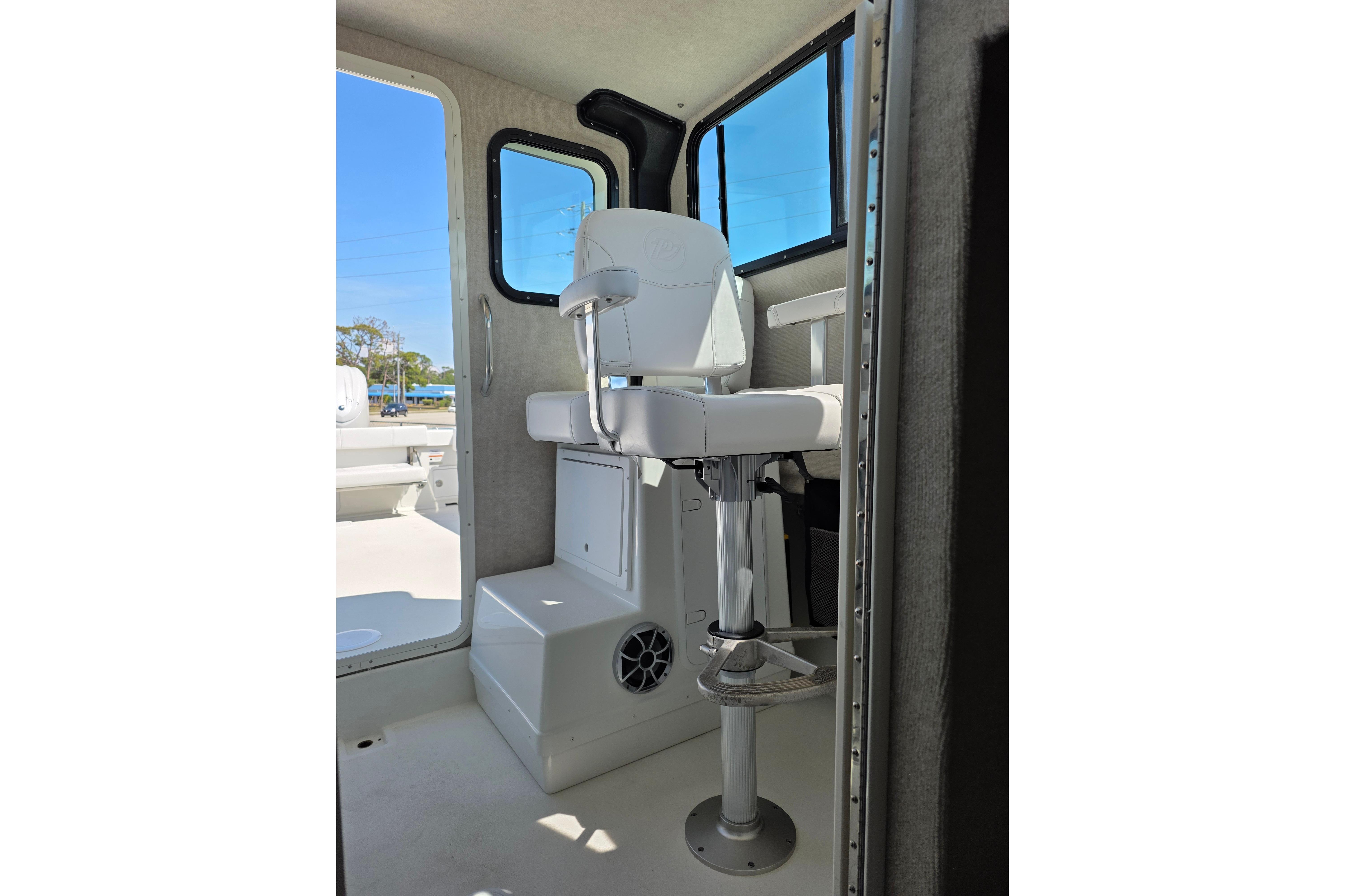Interior of 2026 Parker 287 Explorer boat with white captain's chair and windows.