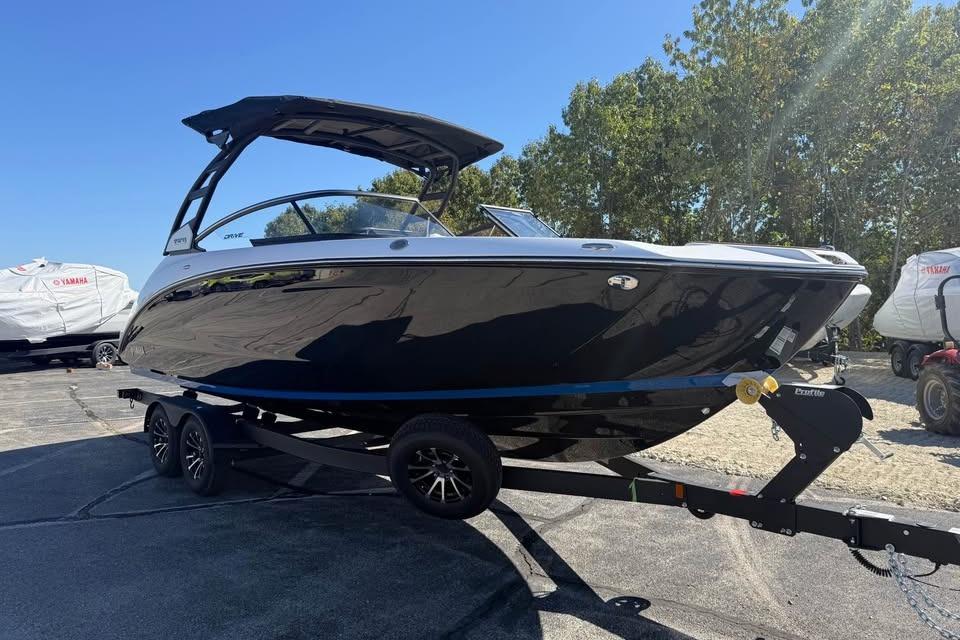 2026 Yamaha Boats 252SD on trailer, sleek black design, parked outdoors.