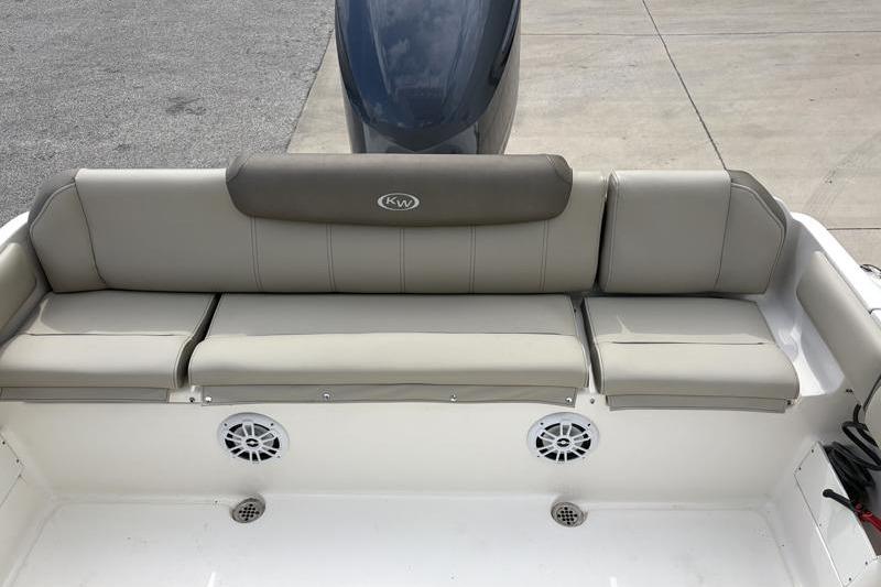 2024 Key West 239 FS boat seating area with gray cushions and speakers.