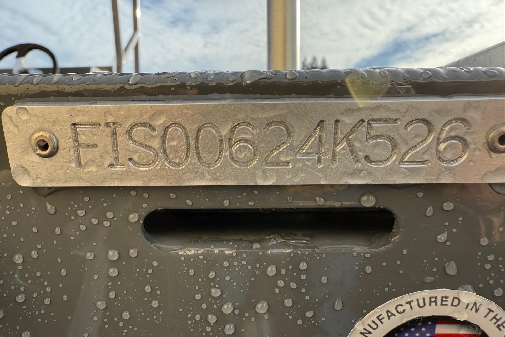 2026 Fish Rite Angler 18 boat with identification number FIS00624K526, wet with water droplets.