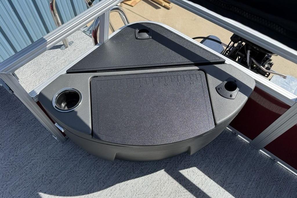 2026 Sun Tracker Bass Buggy 18 DLX boat deck with storage compartment and cup holder.