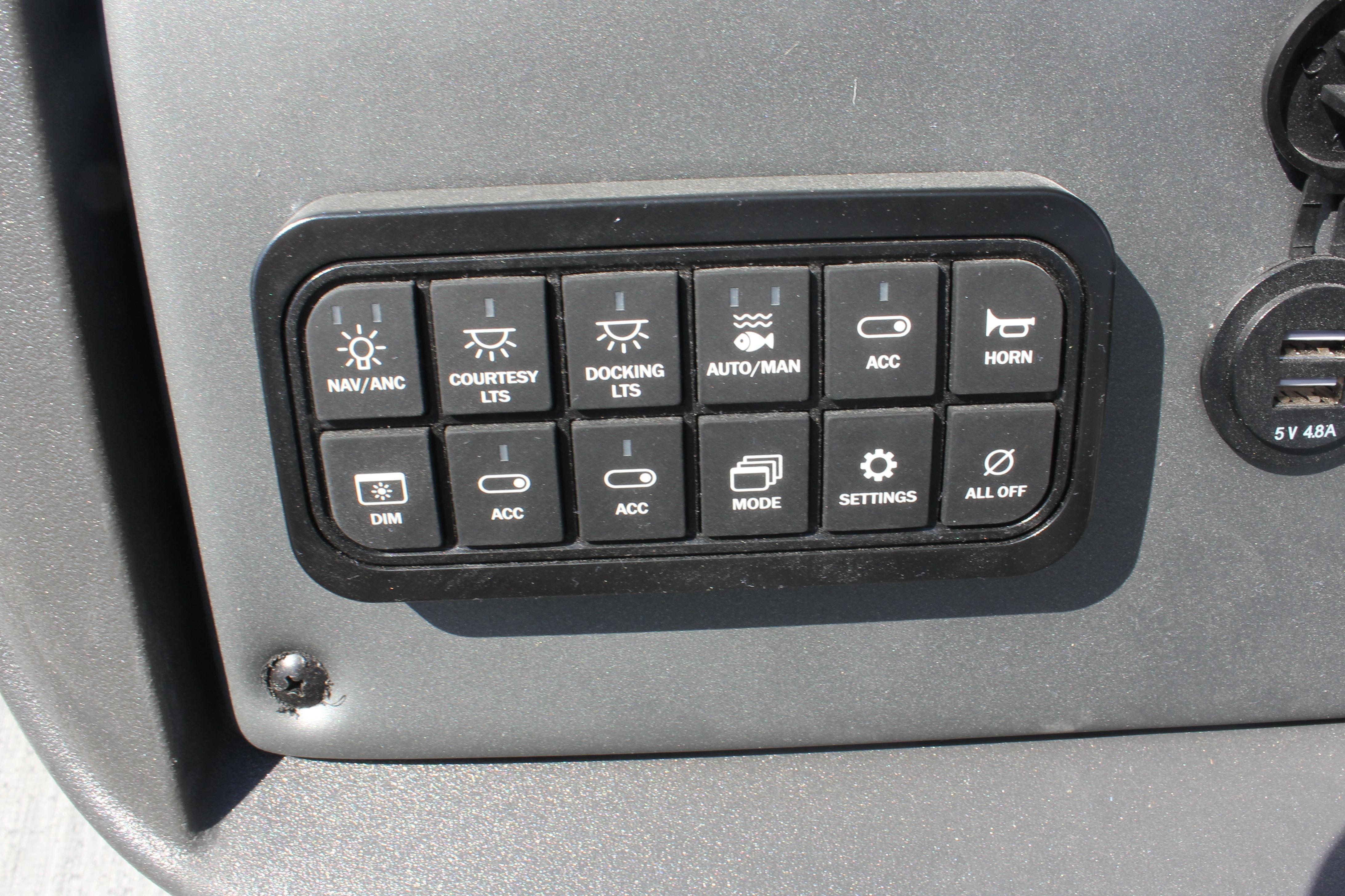 Control panel of 2026 Sun Tracker Fishin' Barge 20 DLX with various function buttons.
