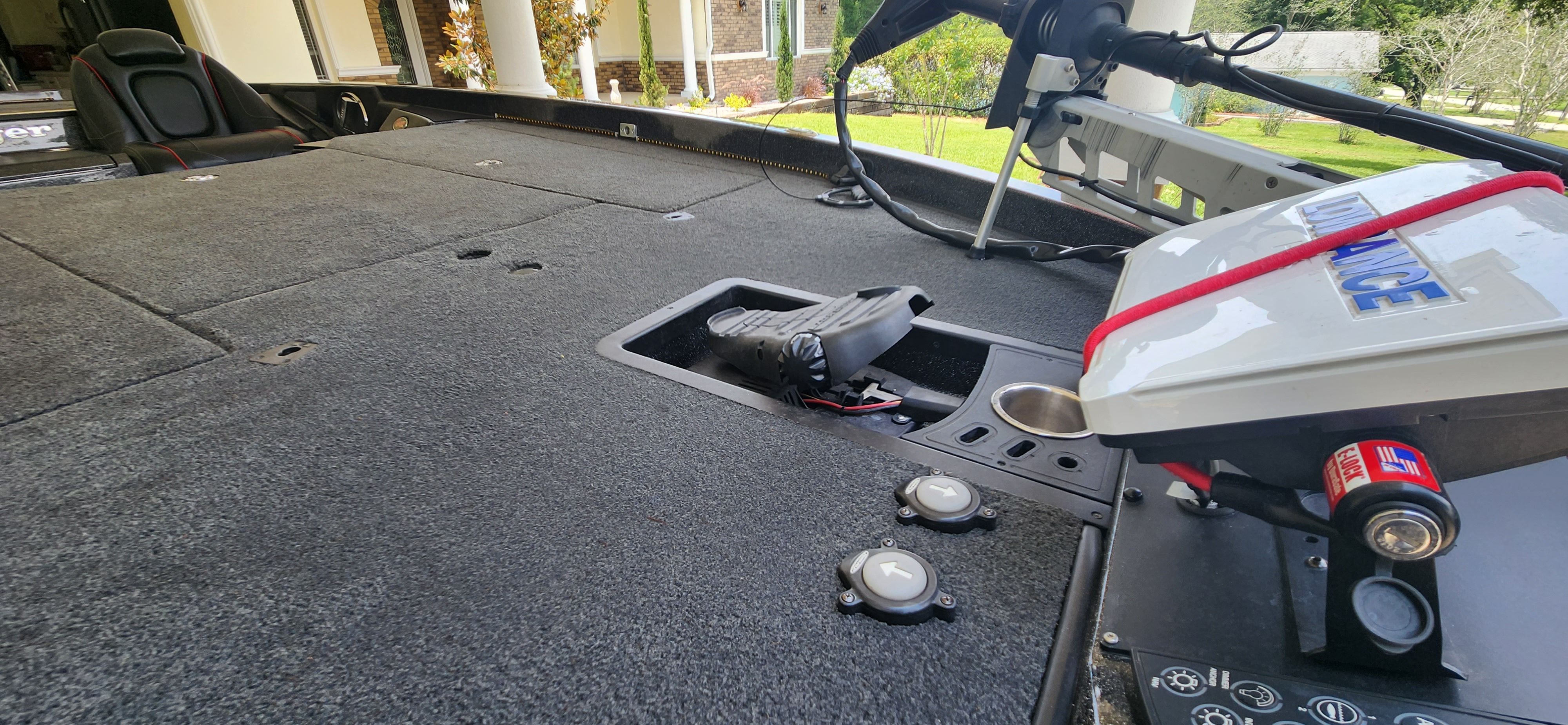 The image shows the deck of a Ranger Z520 Comanche boat with gray carpeting.