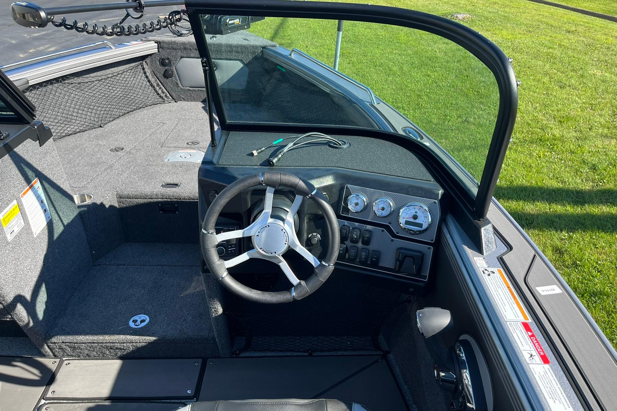 2026 Lund 2275 Baron boat interior with steering wheel and dashboard controls.