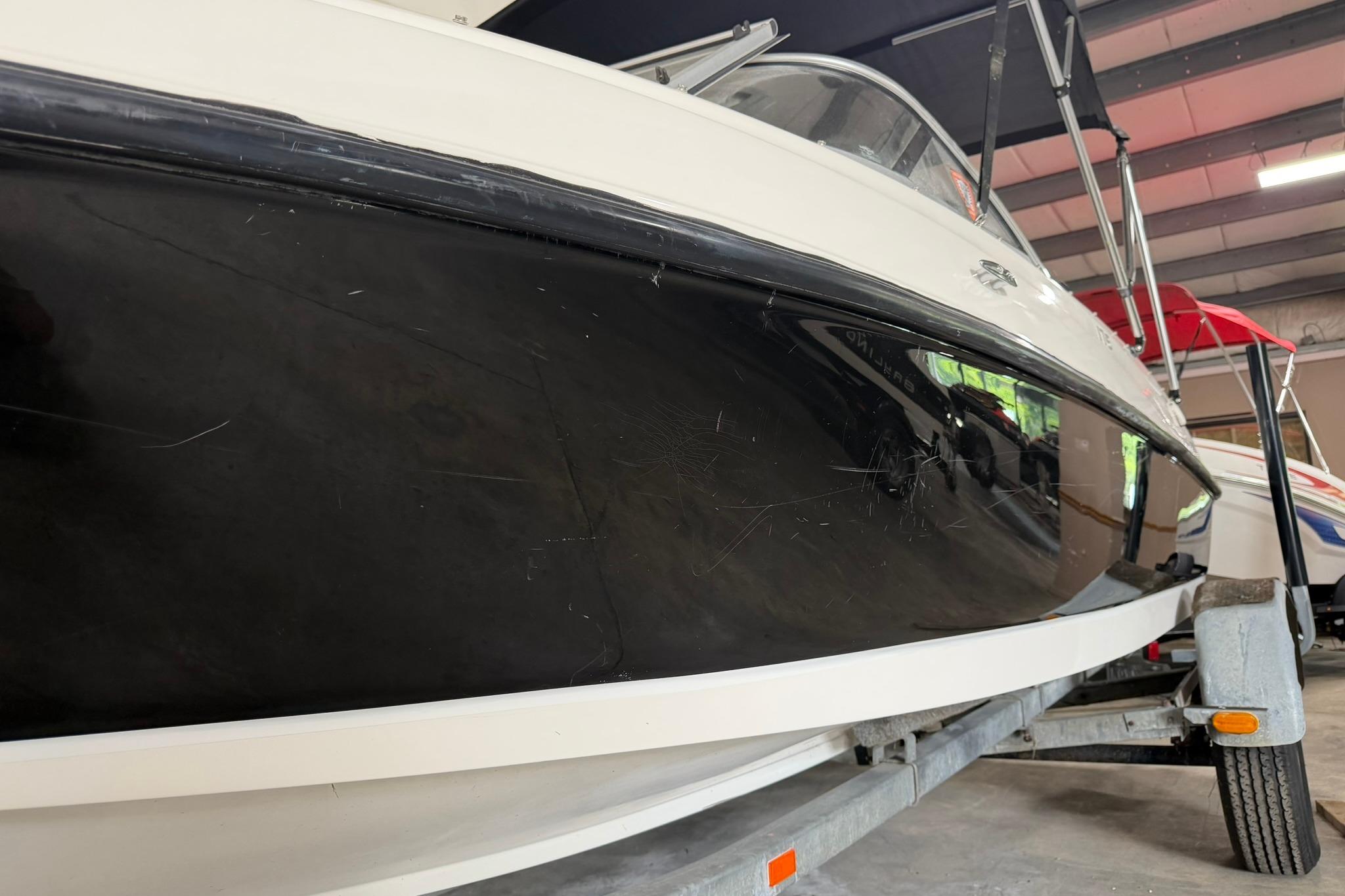 2012 Bayliner 175 Bowrider boat on trailer in indoor storage facility.