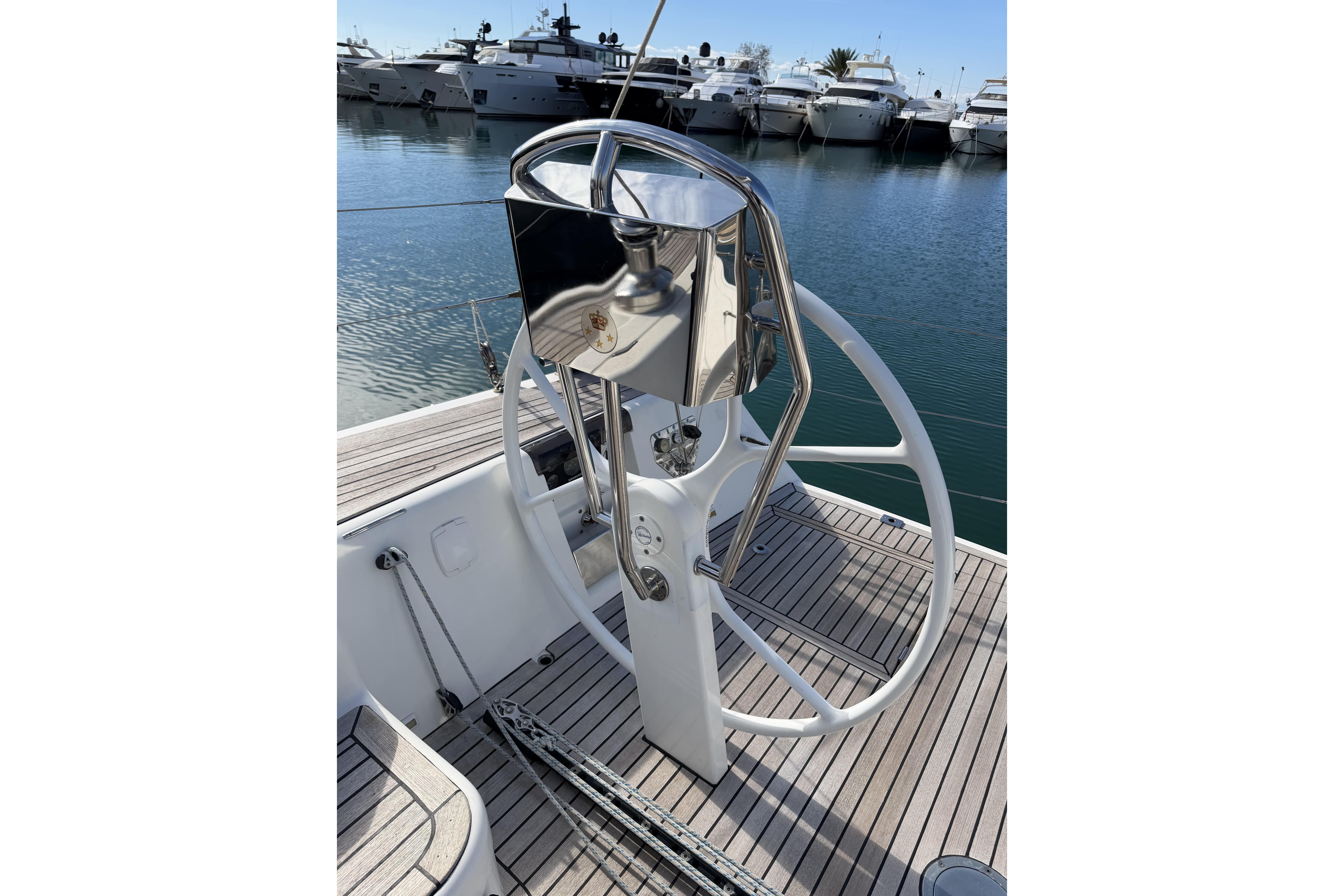 Steering wheel of 2011 X-Yachts X-55 sailboat docked in marina.