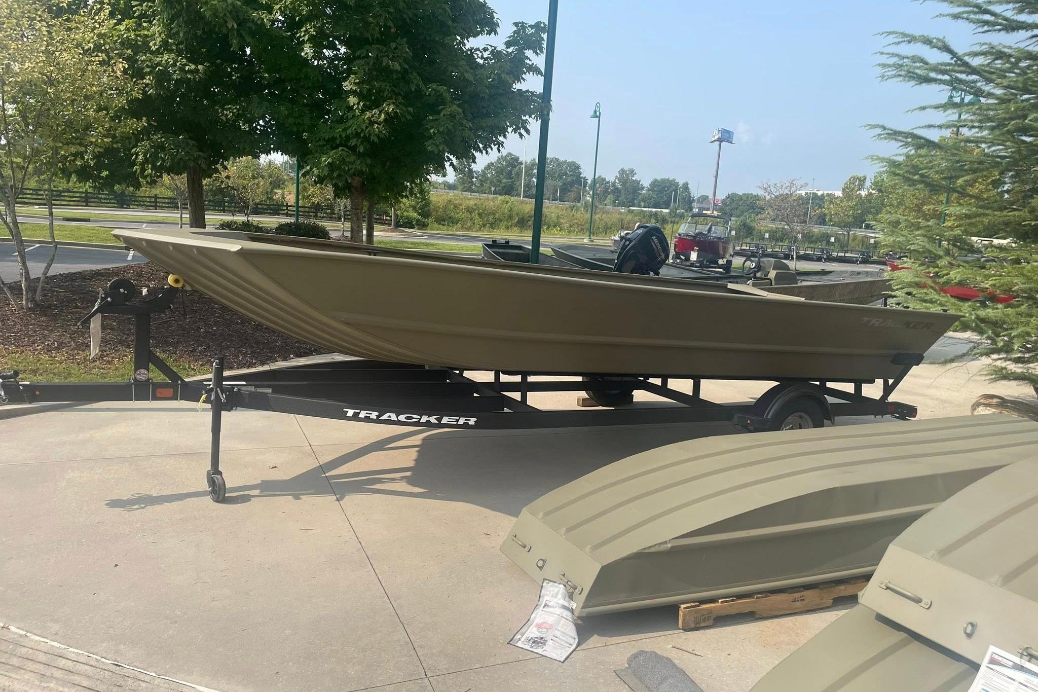2026 Tracker Grizzly 2072 Utility boat on trailer, parked outdoors near trees.
