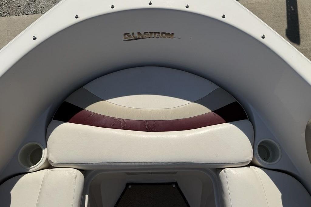 1999 Glastron GT 225 boat interior with white and maroon seating.