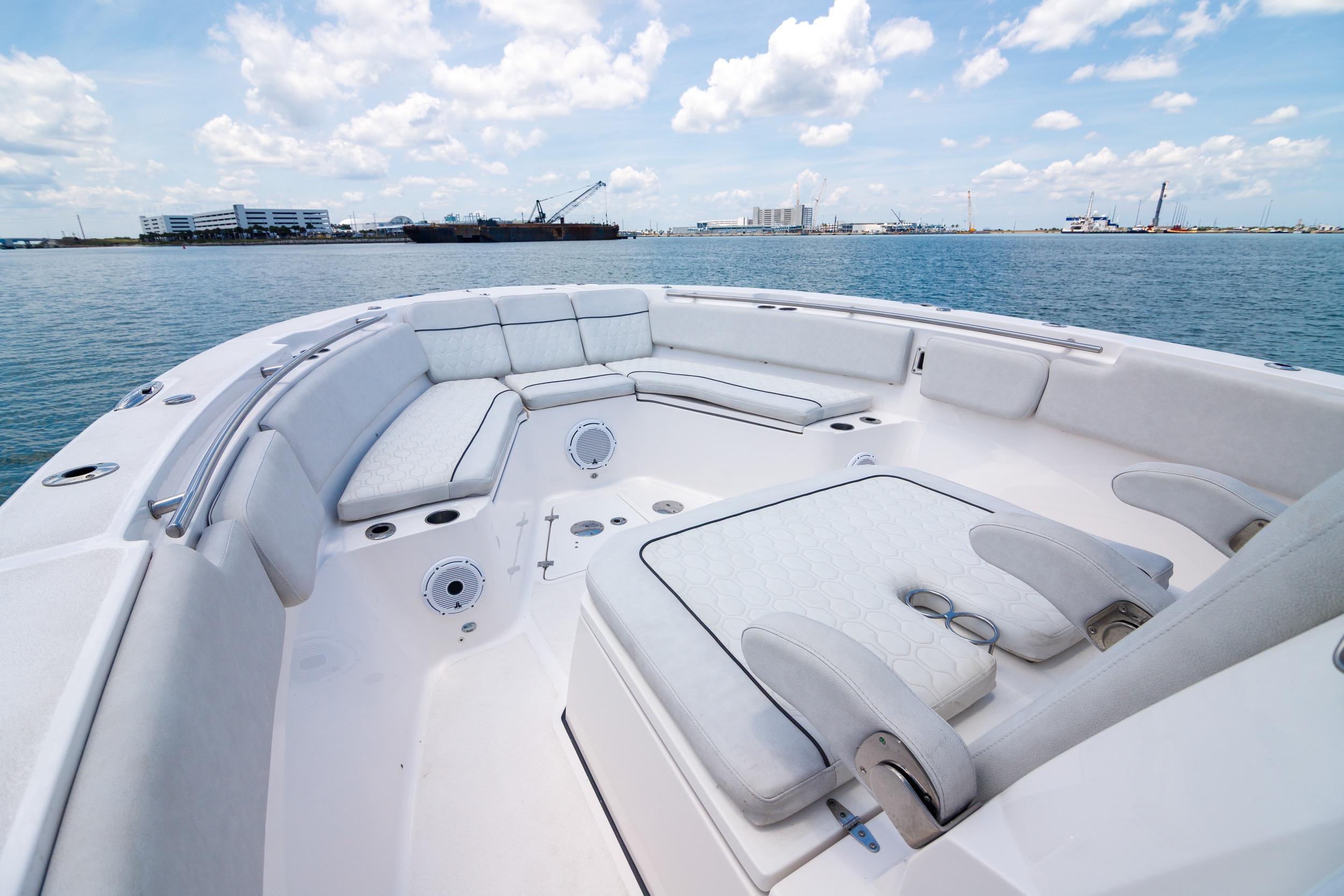 2021 Sea Fox 328 Commander boat with spacious seating, docked in a scenic harbor.
