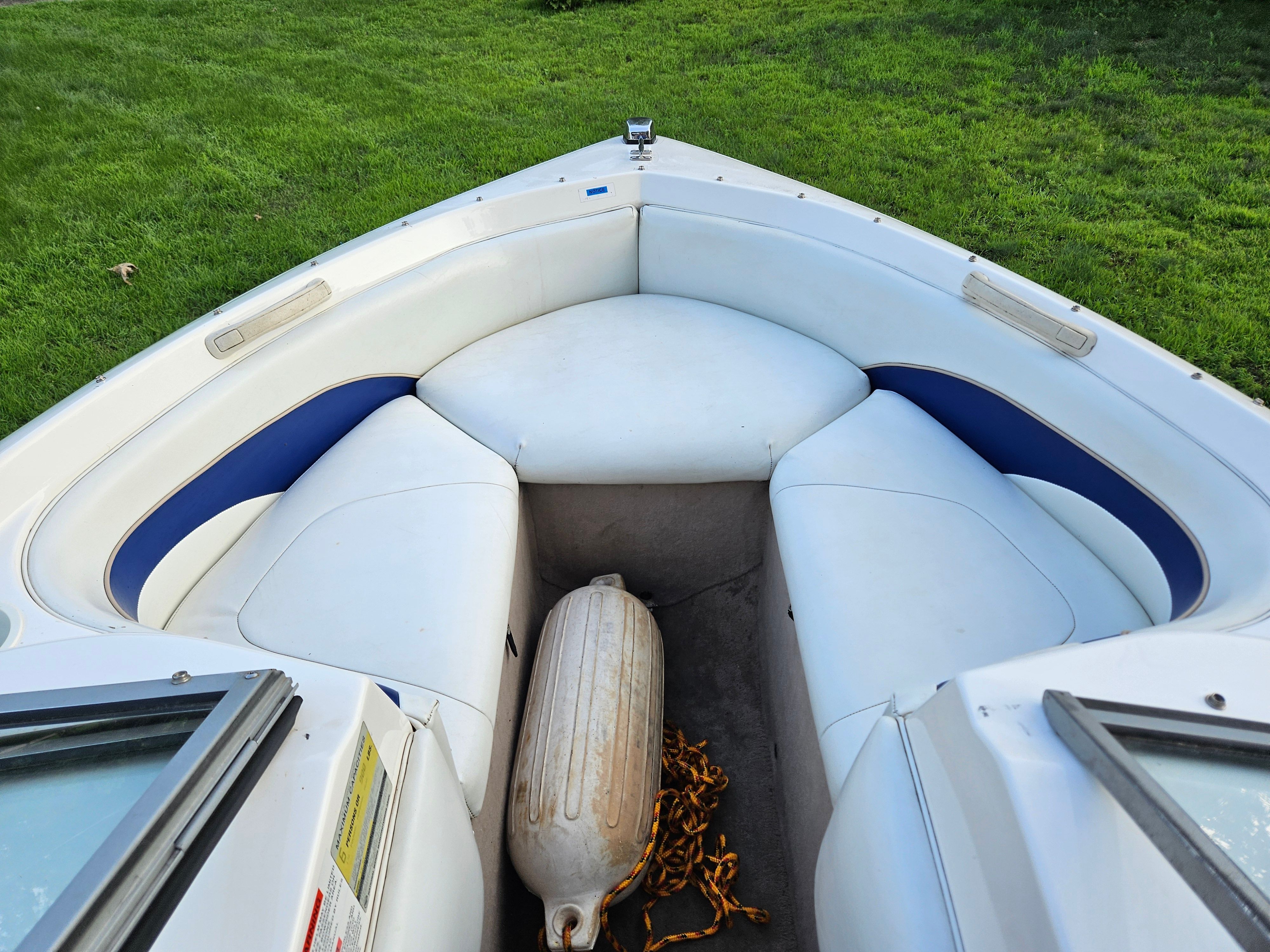 The image shows the bow of a 1996 Wellcraft Excel boat with white upholstery.