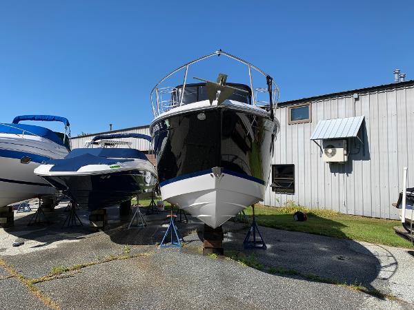 A 2017 Regal 26 Express boat is on dry dock next to other boats.