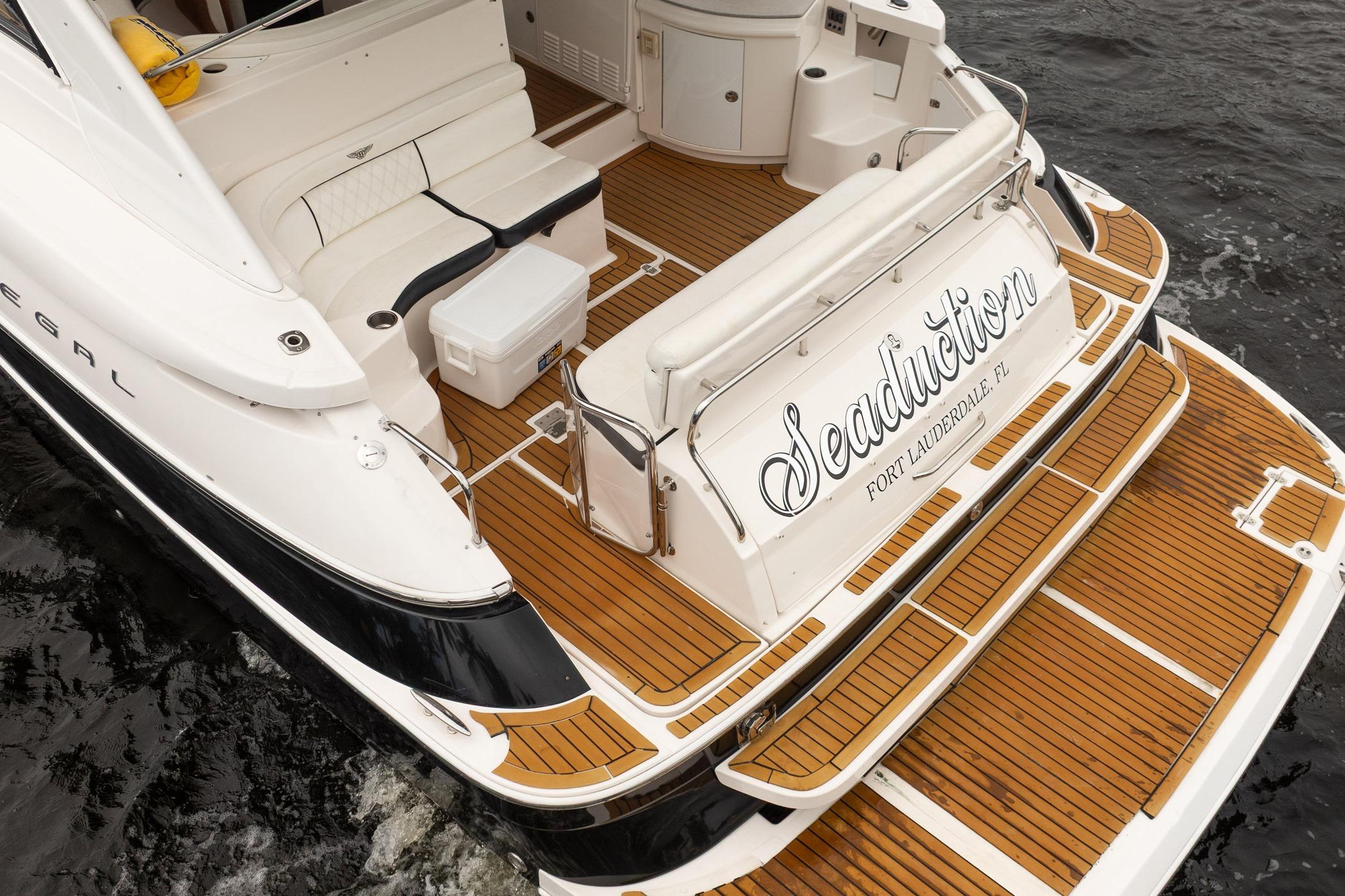 2008 Regal Commodore 4460 yacht with teak deck, named "Seaduction," docked in Fort Lauderdale.