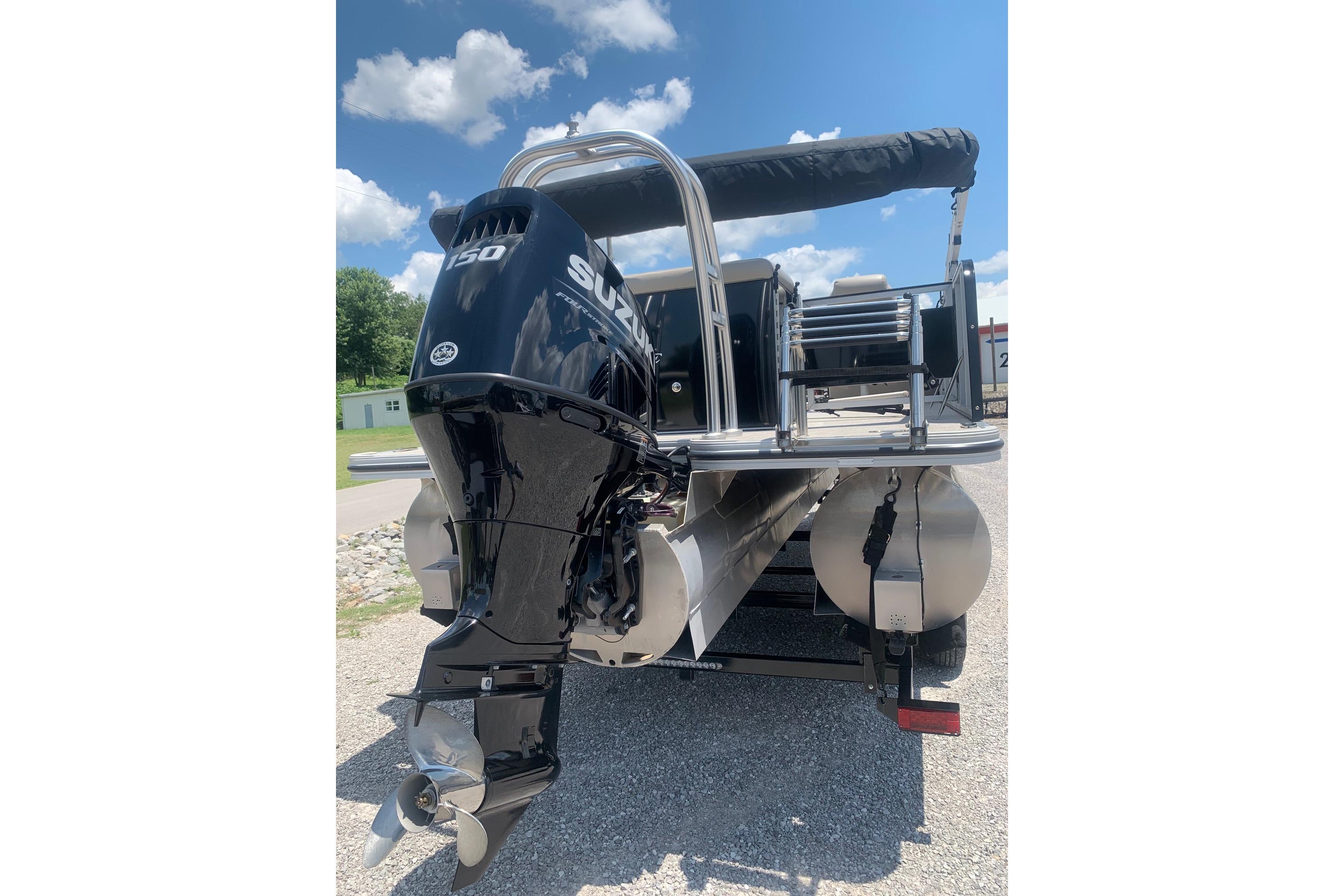 2023 Silver Wave 2410 SW3 CLS boat with Suzuki 150 outboard motor, parked outdoors.