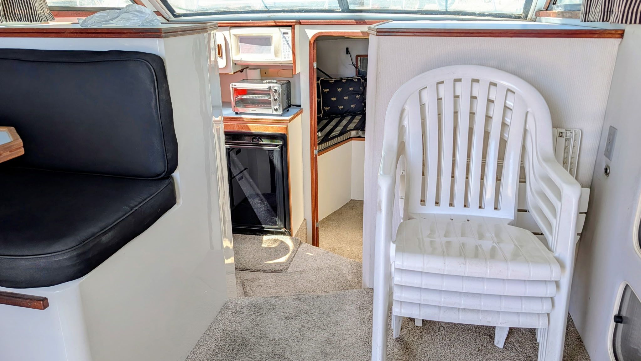 Interior of a 1987 Chris-Craft 320 Amerosport Express with seating area and small kitchen.