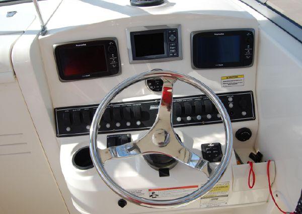 Steering console of 2011 Boston Whaler 235 Conquest with navigation instruments.