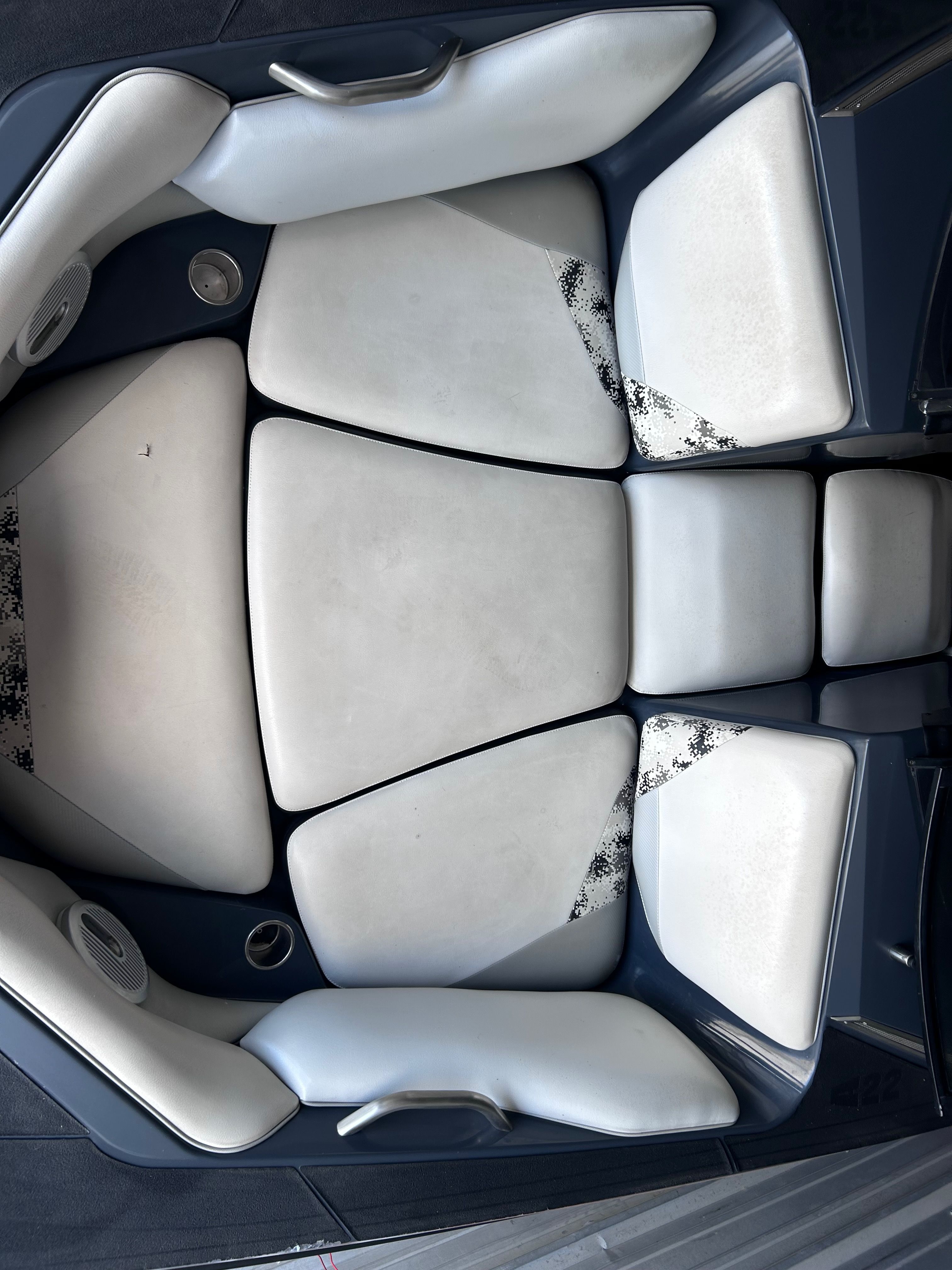 Interior of a 2013 Axis A22 boat with white upholstery.