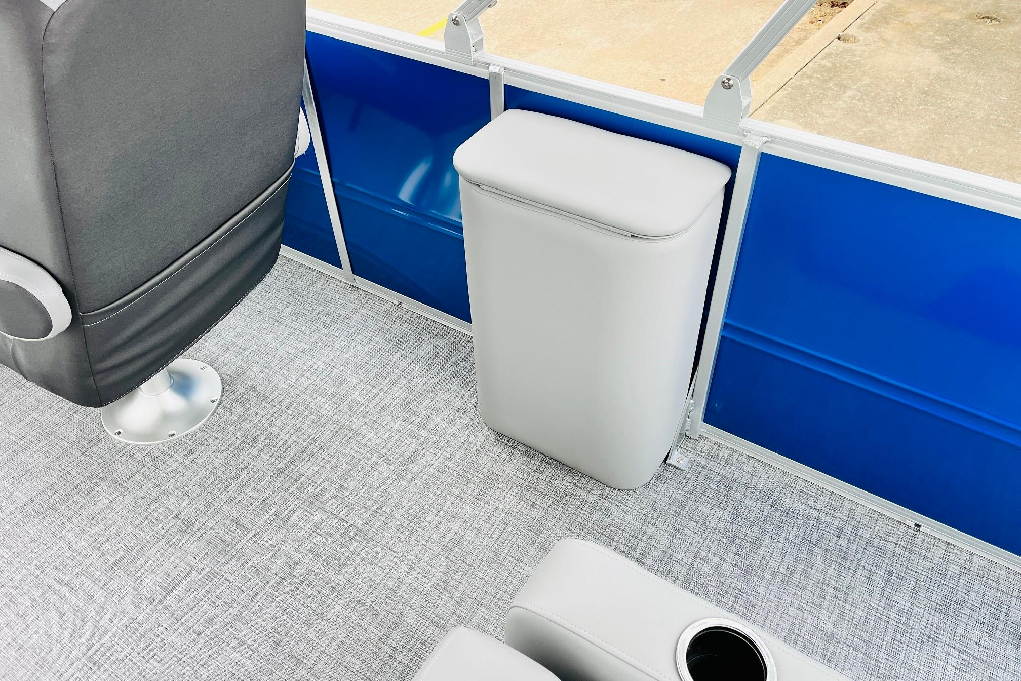 Interior of 2026 Sun Tracker Party Barge 22 RF DLX, featuring seating and blue paneling.