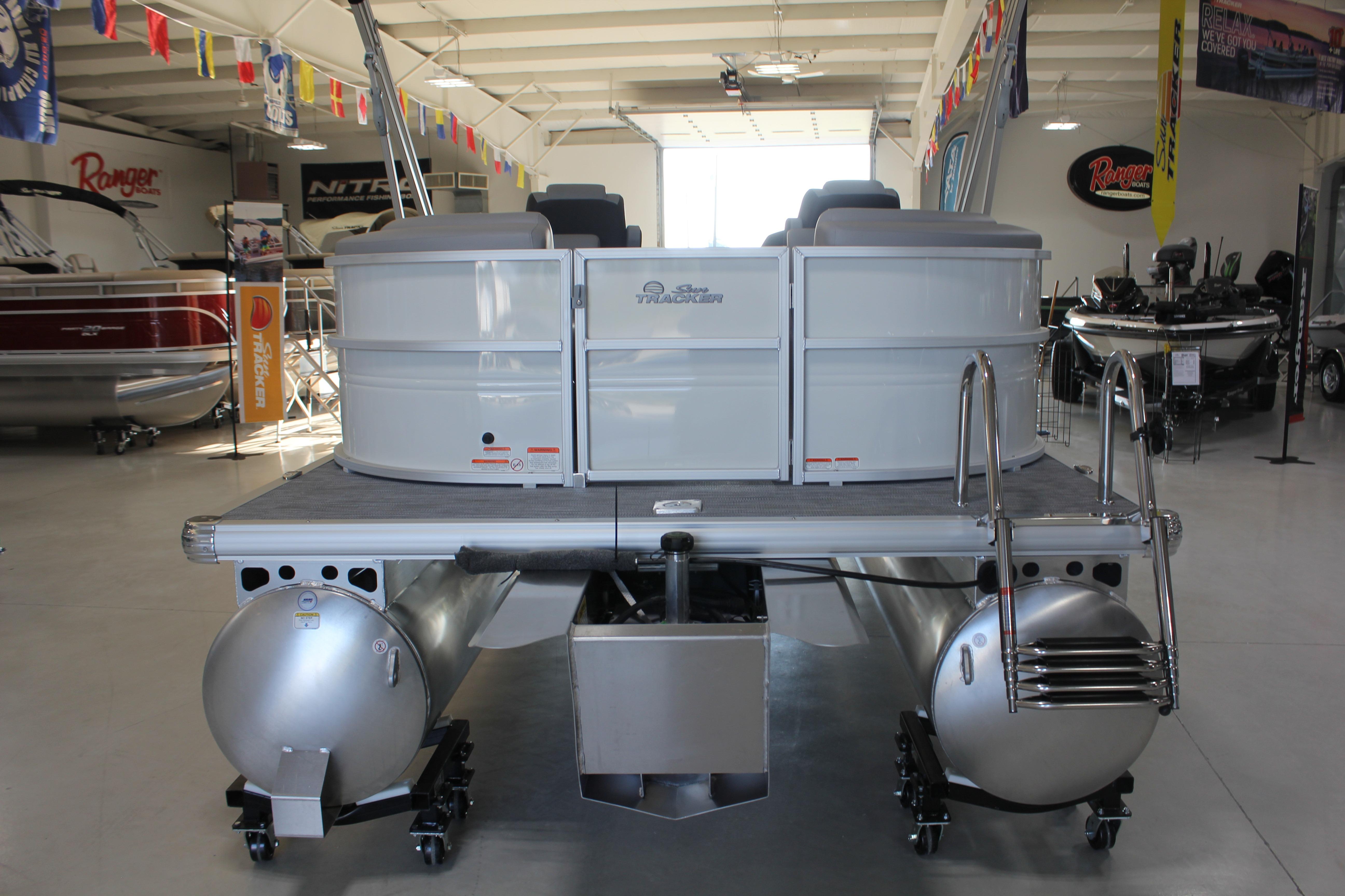 2026 Sun Tracker Party Barge 22 DLX pontoon boat displayed in a showroom.