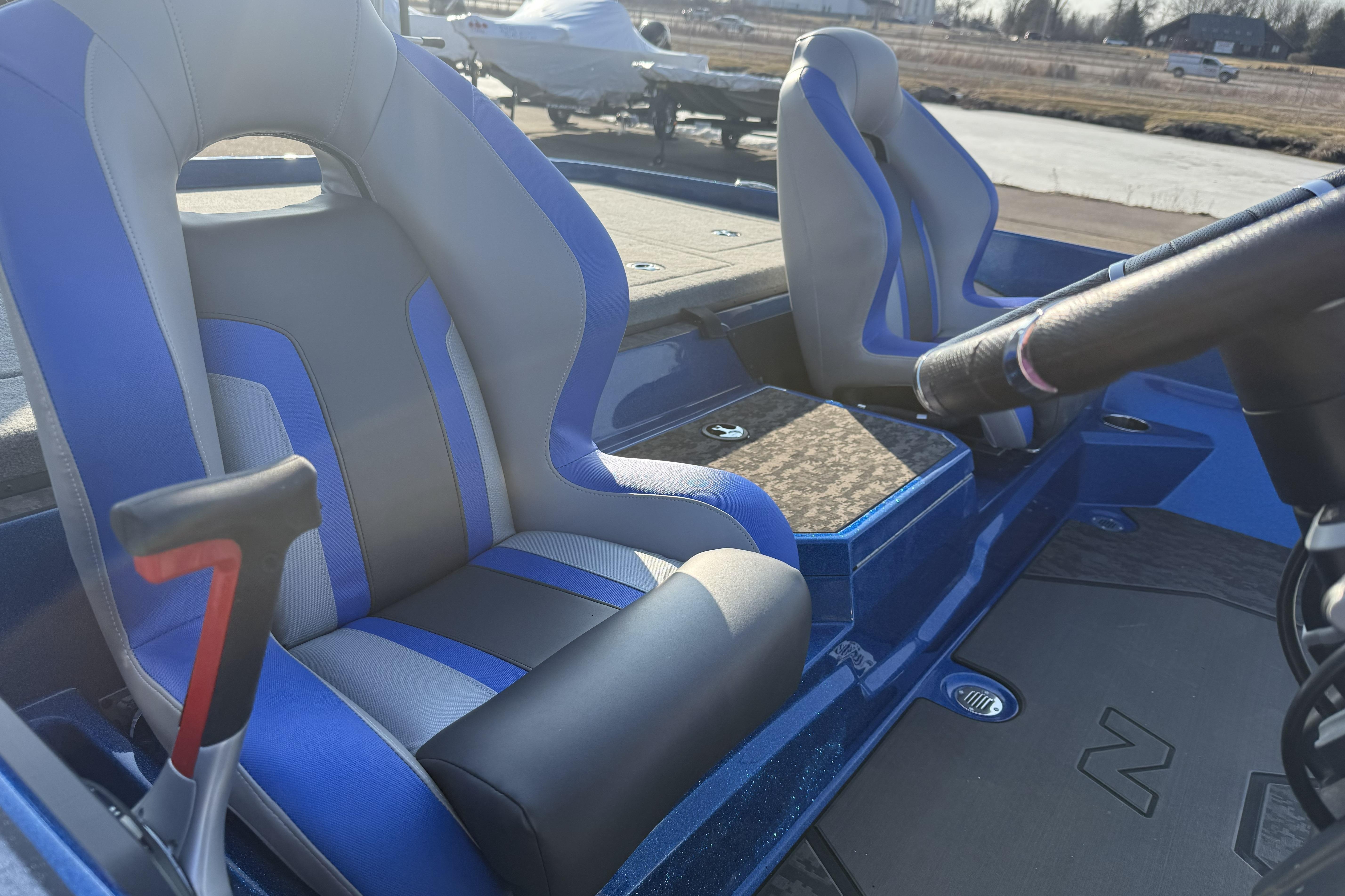 2026 Nitro Z21 XL Pro boat interior with blue and gray seats, steering wheel visible.