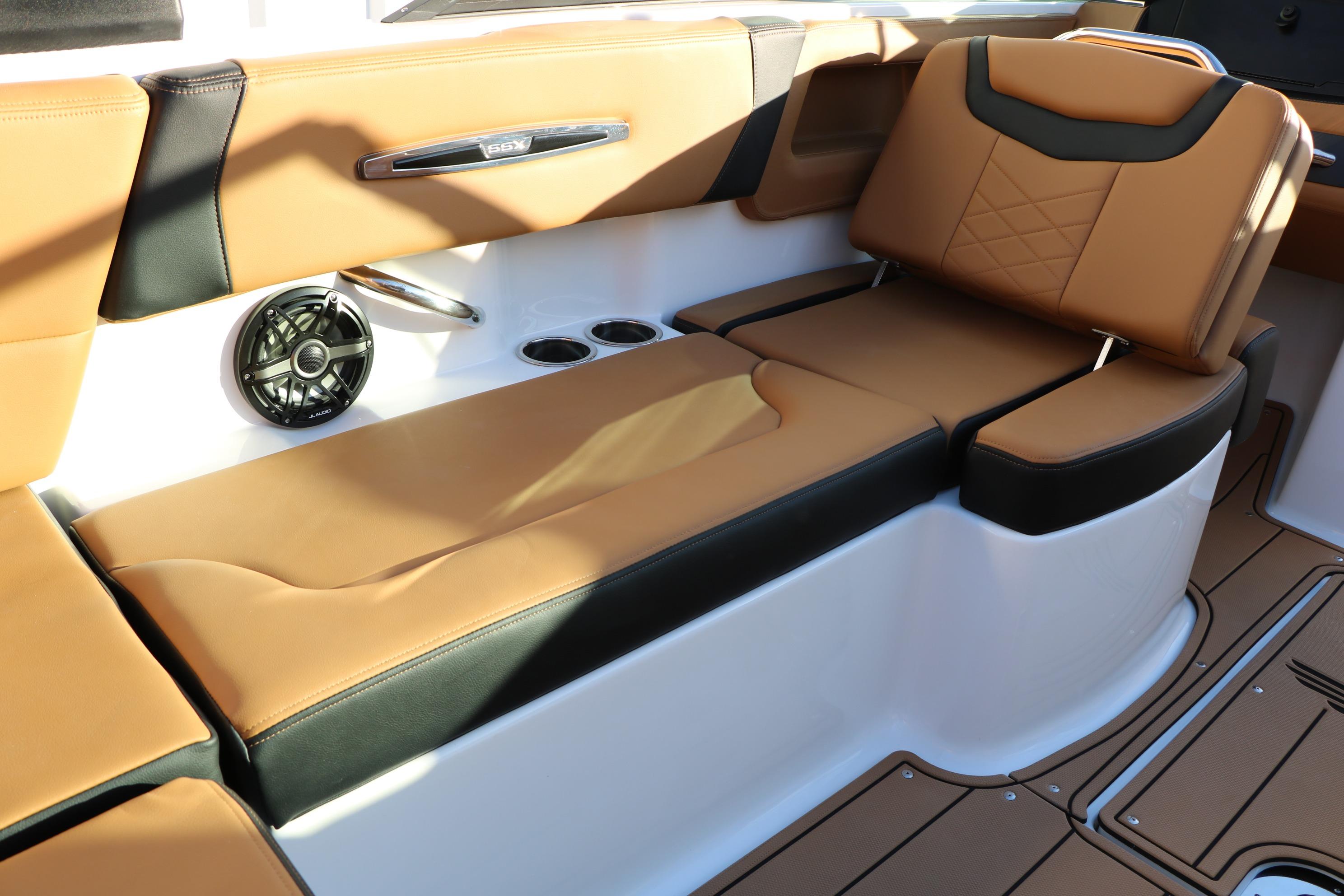 Luxurious seating in 2026 Chaparral 247 SSX boat with tan and black upholstery.