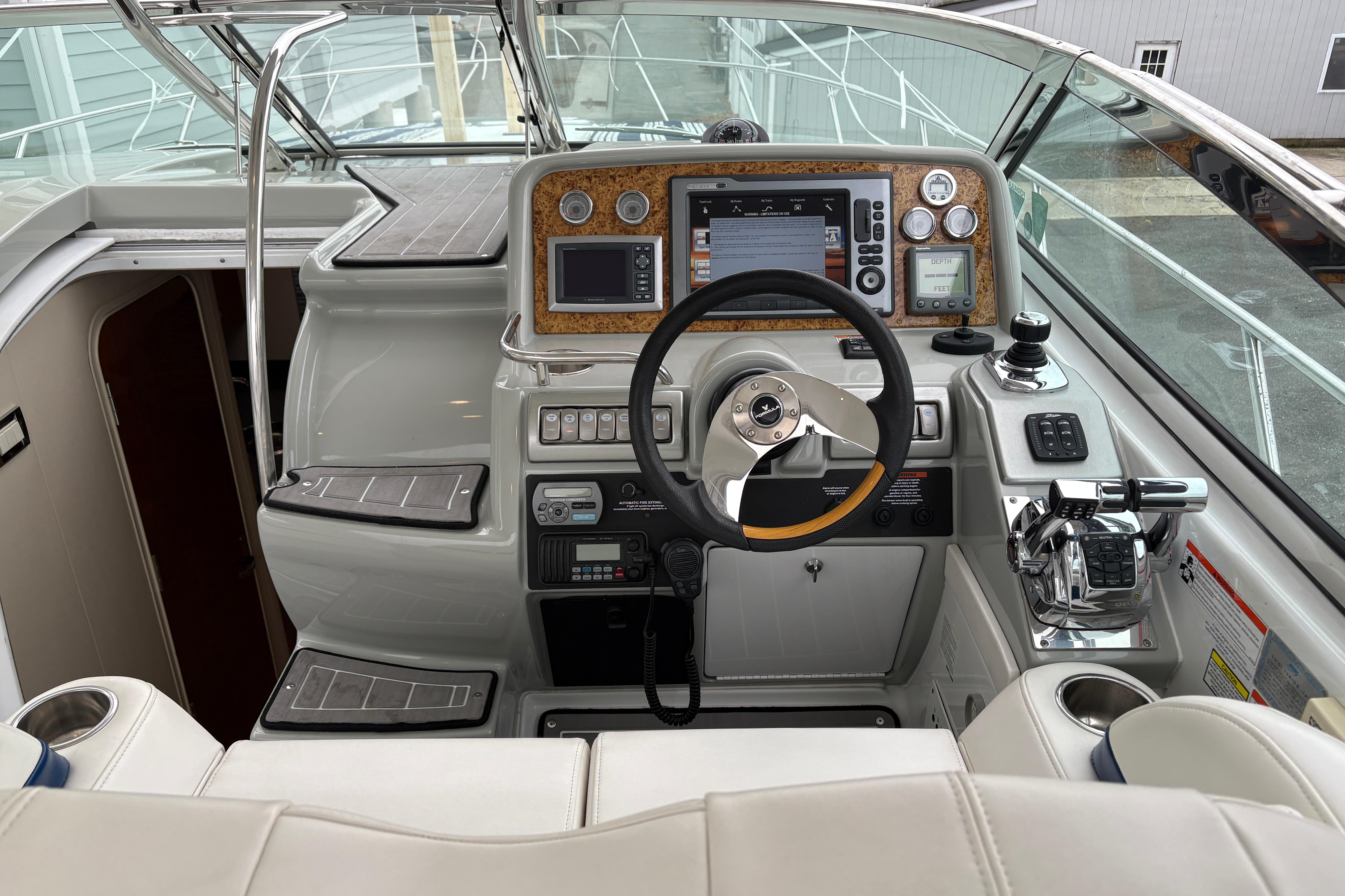 Cockpit of 2011 Formula 34 Performance Cruiser with modern navigation controls and steering wheel.