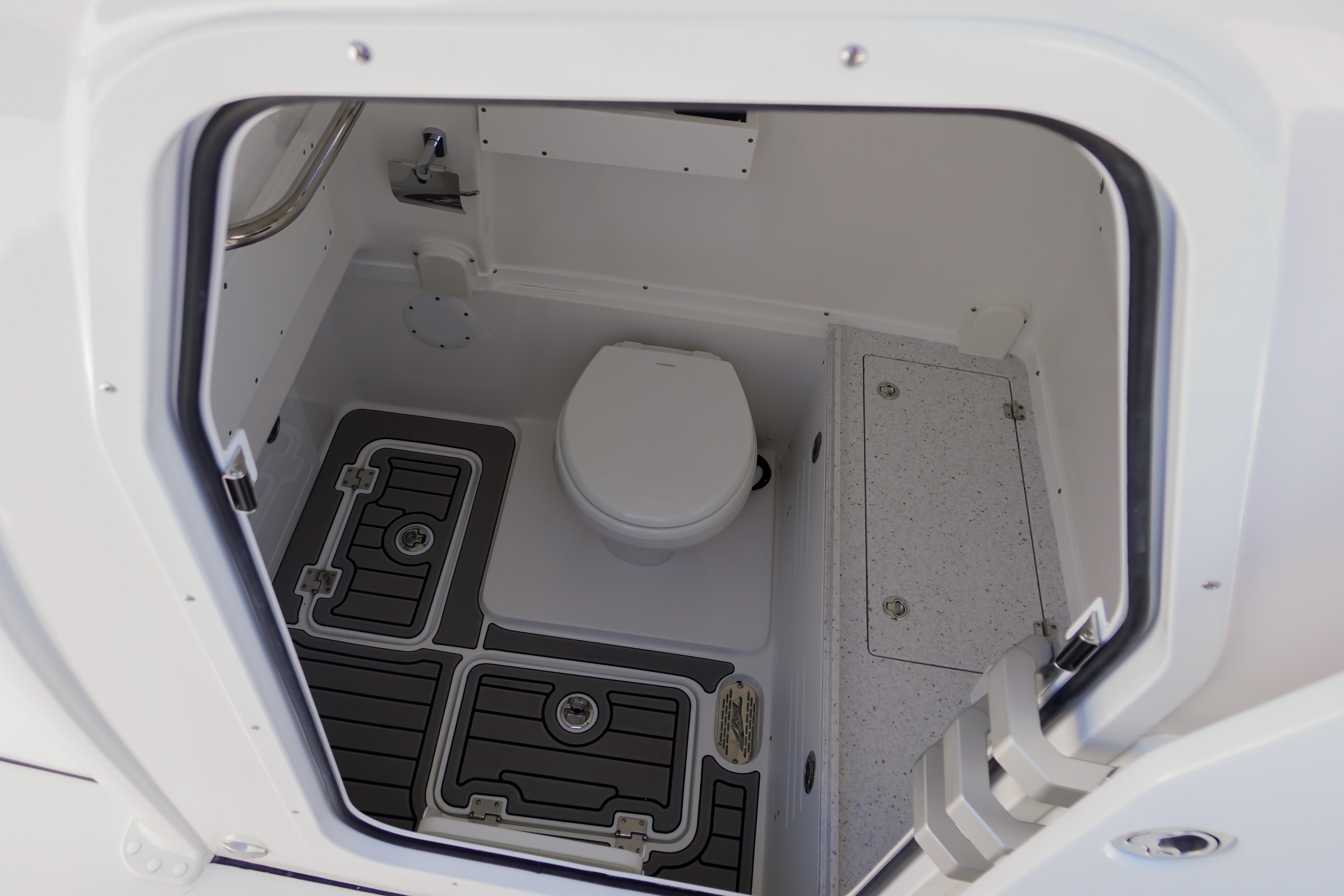 Interior view of 2026 Tidewater 302 CC Adventure boat's compact bathroom.