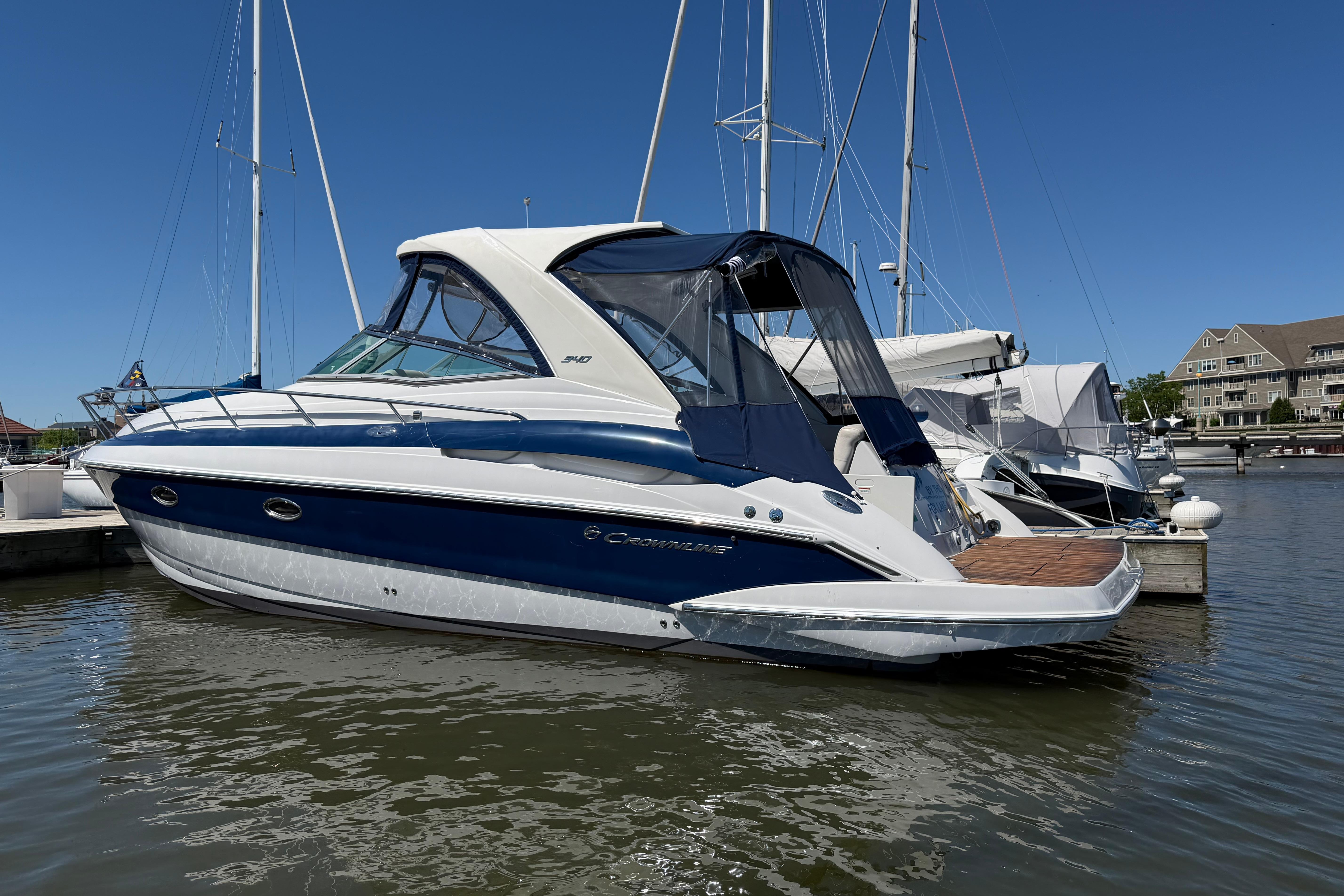 2008 Crownline 340 CR boat docked at marina under clear blue sky.