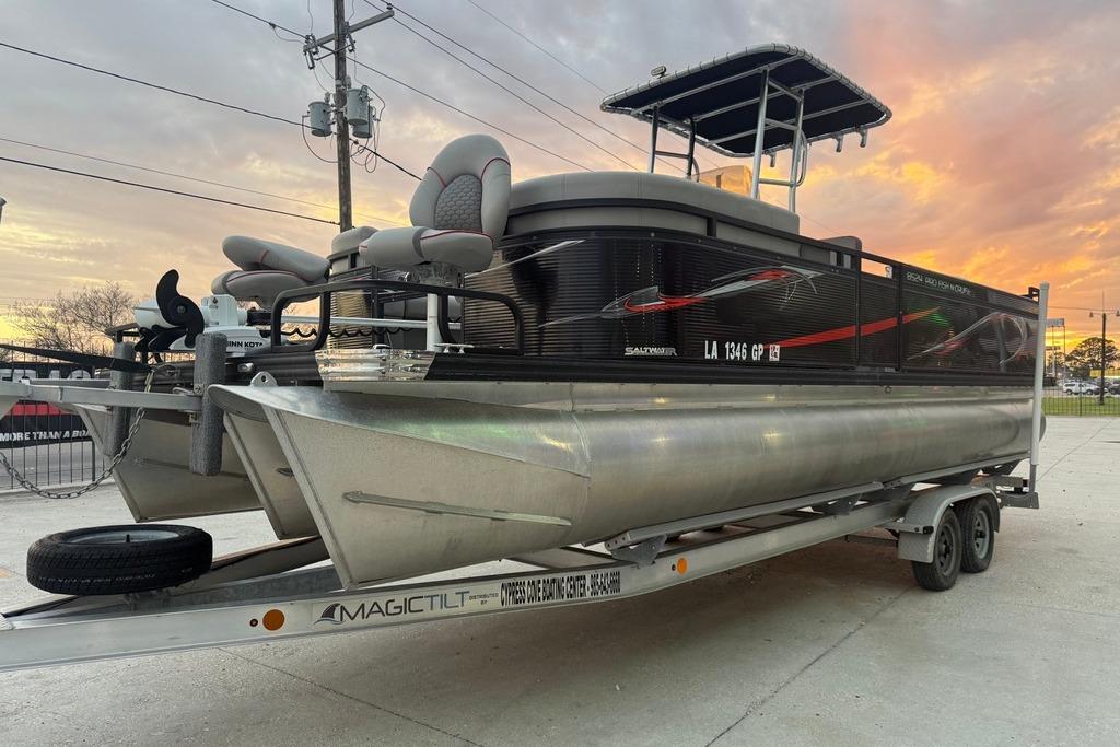 2022 Apex Marine 8524 Pro Fish N Cruise pontoon boat on trailer at sunset.