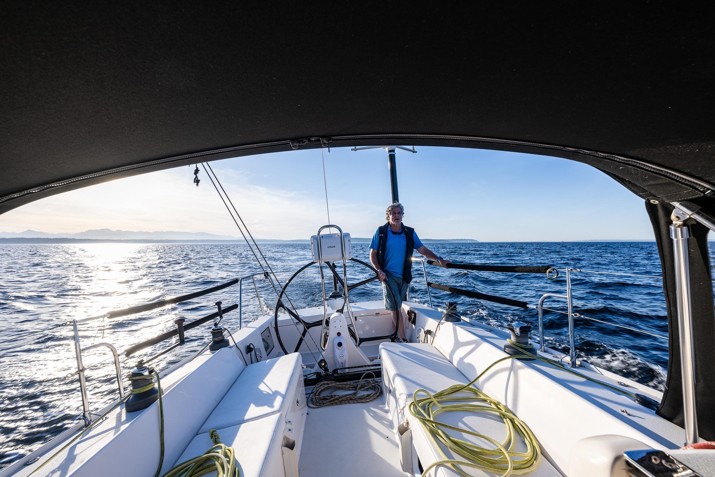 Sailing a 2007 J Boats J/124 yacht on open sea under clear skies.