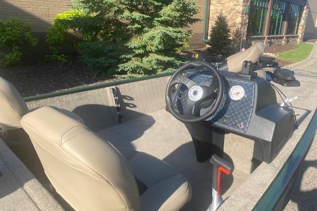 2026 Tracker Bass Tracker Classic Limited boat interior with steering wheel and beige seats.