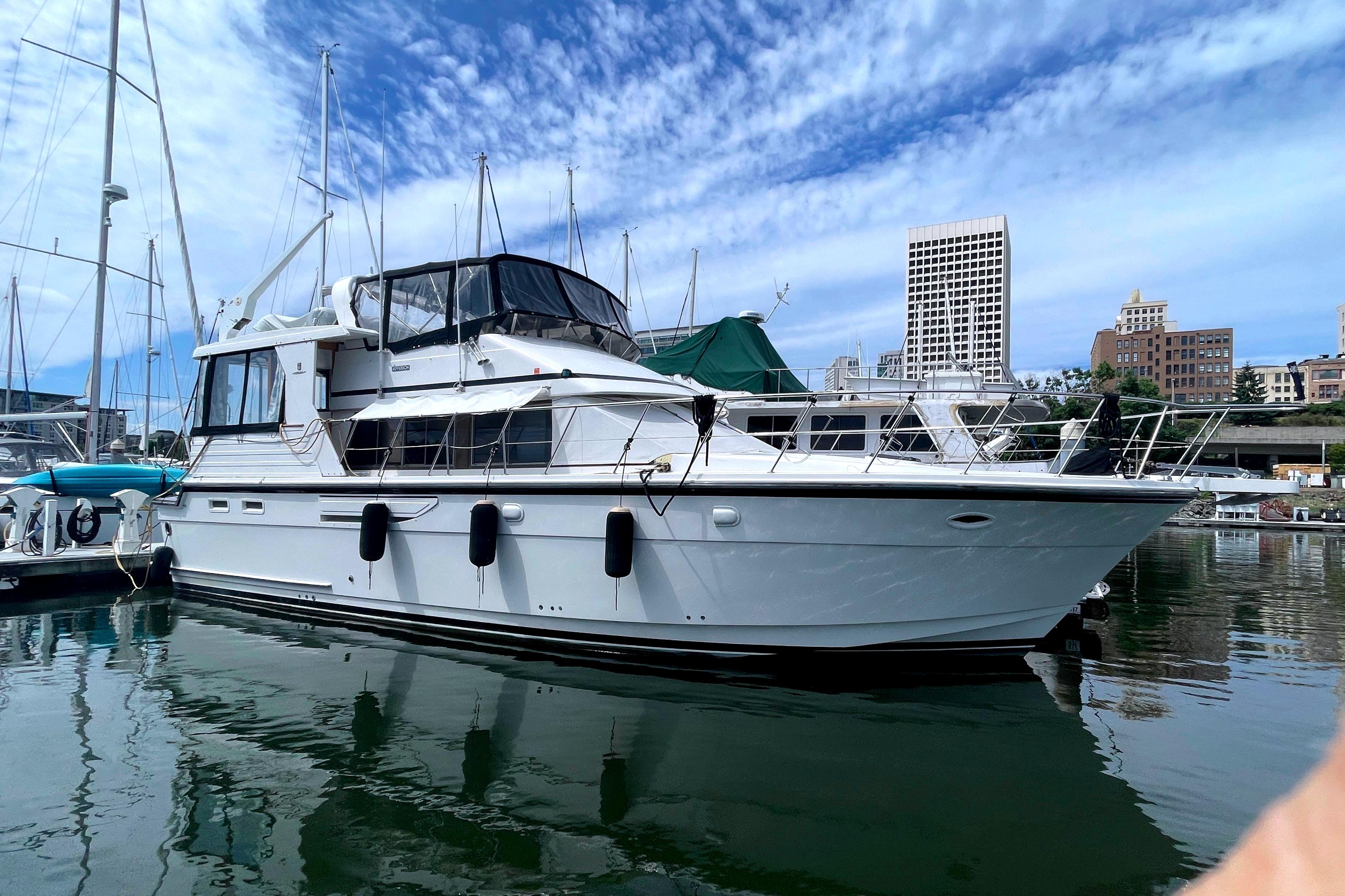 1991 Jefferson 48 Rivanna Sundeck yacht docked, blue sky.