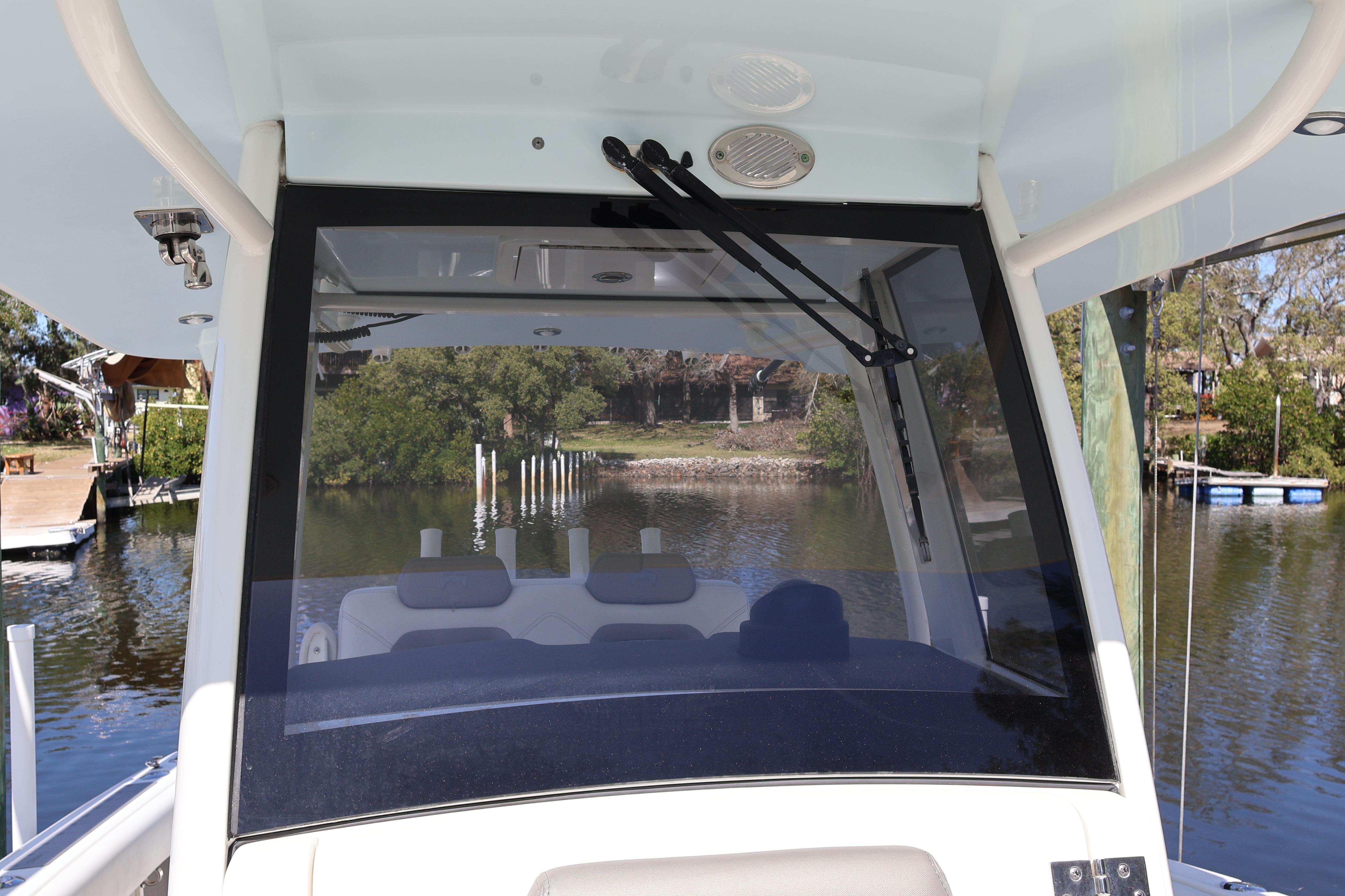 2022 World Cat 280 CC-X boat windshield view with scenic waterway background.