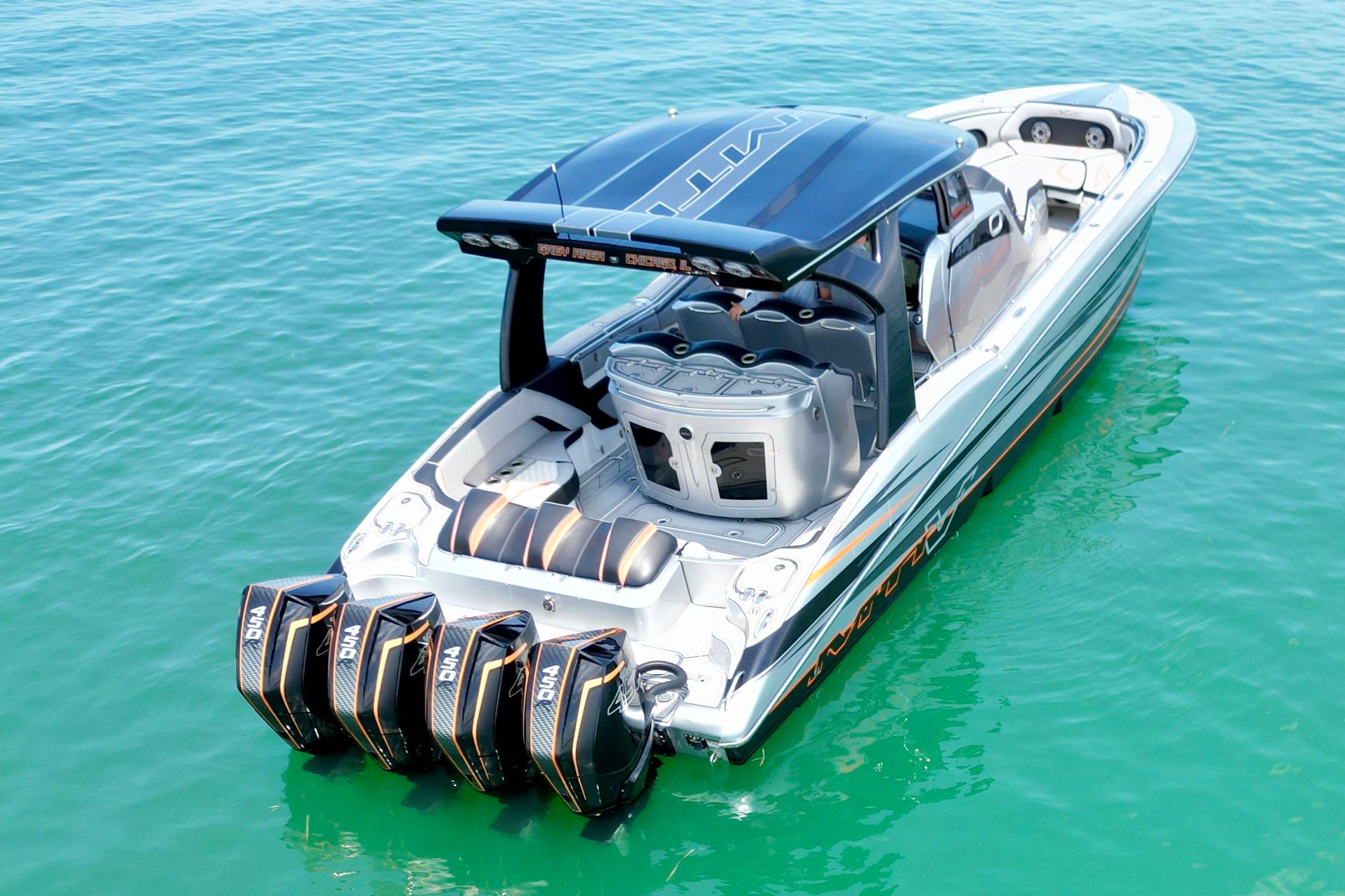 2017 MTI V42 boat with four powerful engines on turquoise water.