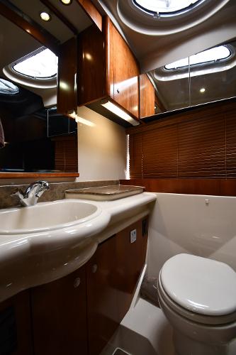 Luxurious bathroom in 2010 Cruisers Yachts 390 Sports Coupe with modern fixtures and wood accents.