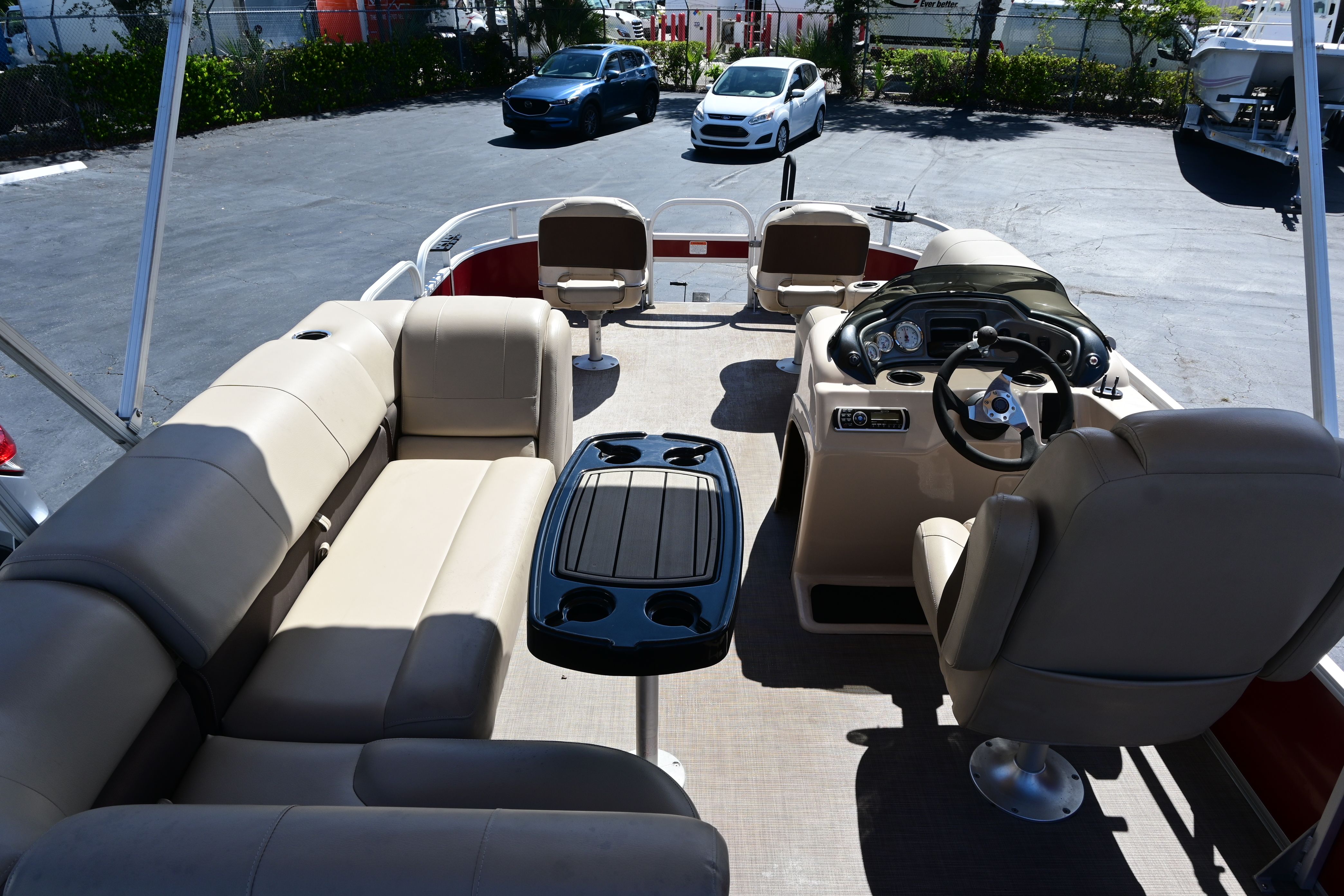 Interior of a 2019 Sun Tracker FISHI pontoon boat with beige seating.