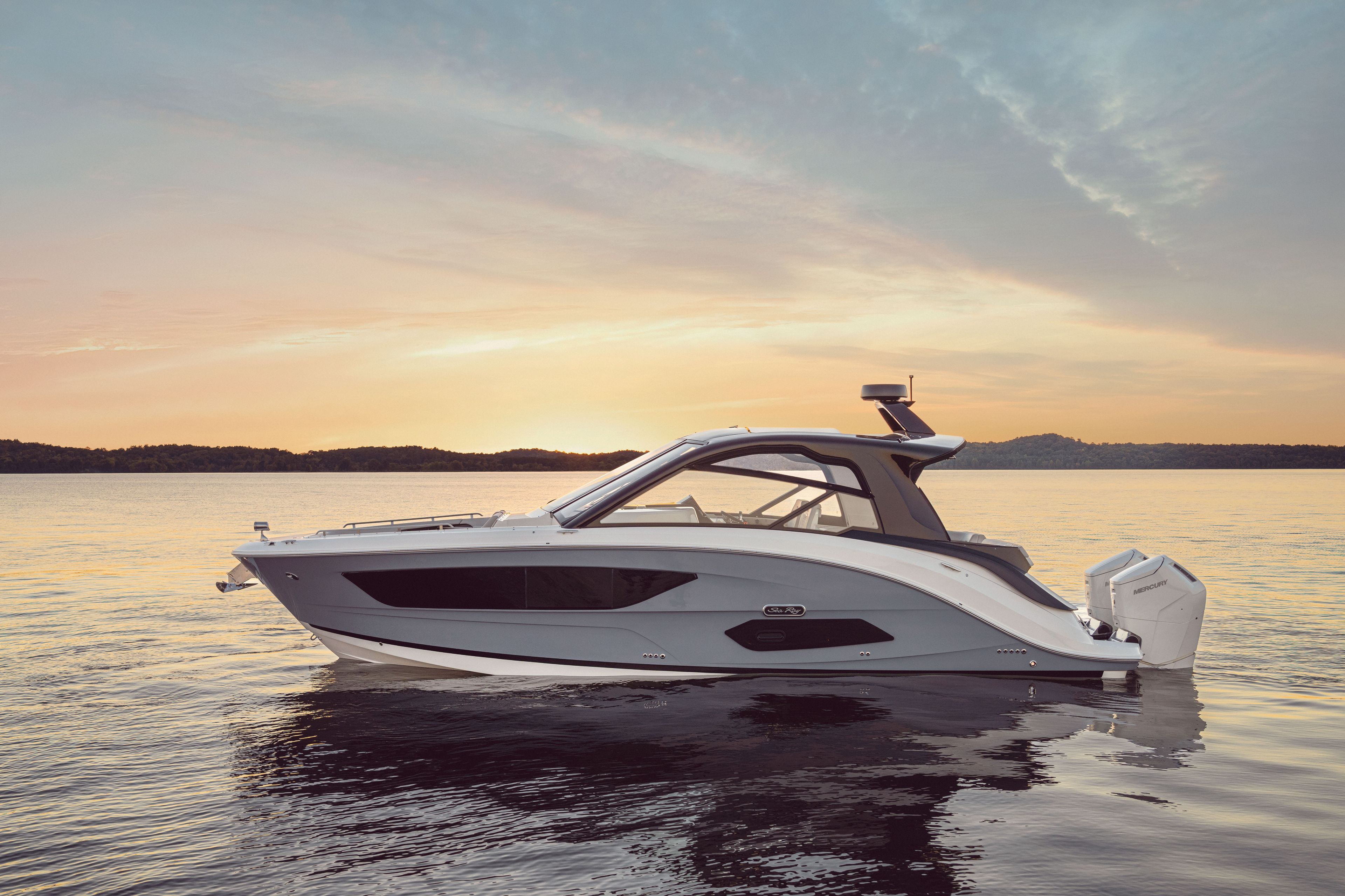 Sea Ray Sundancer 370 Outboard 2026 on calm water at sunset.