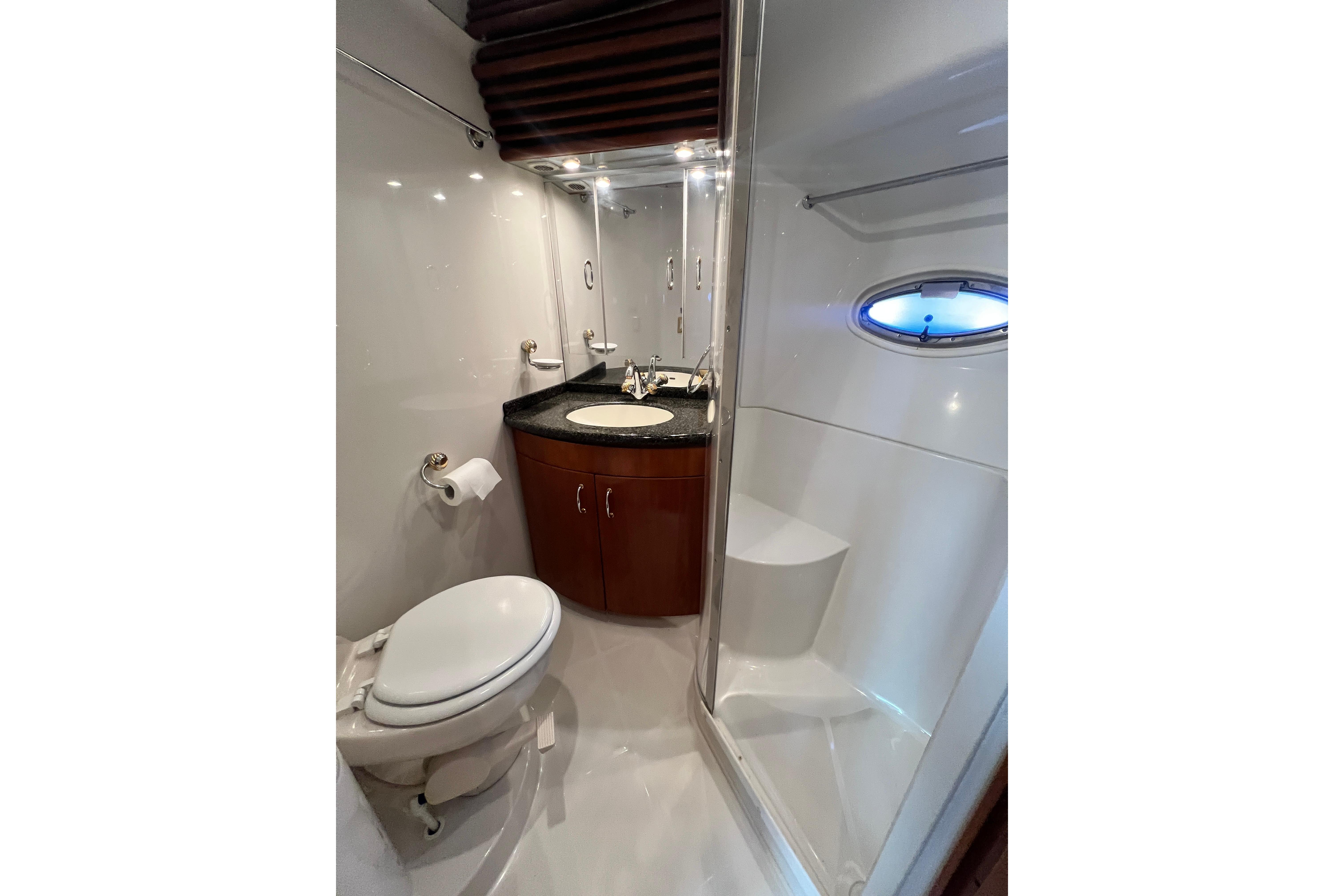 Luxurious bathroom in 2003 Carver 450 Voyager Pilothouse yacht with modern fixtures.