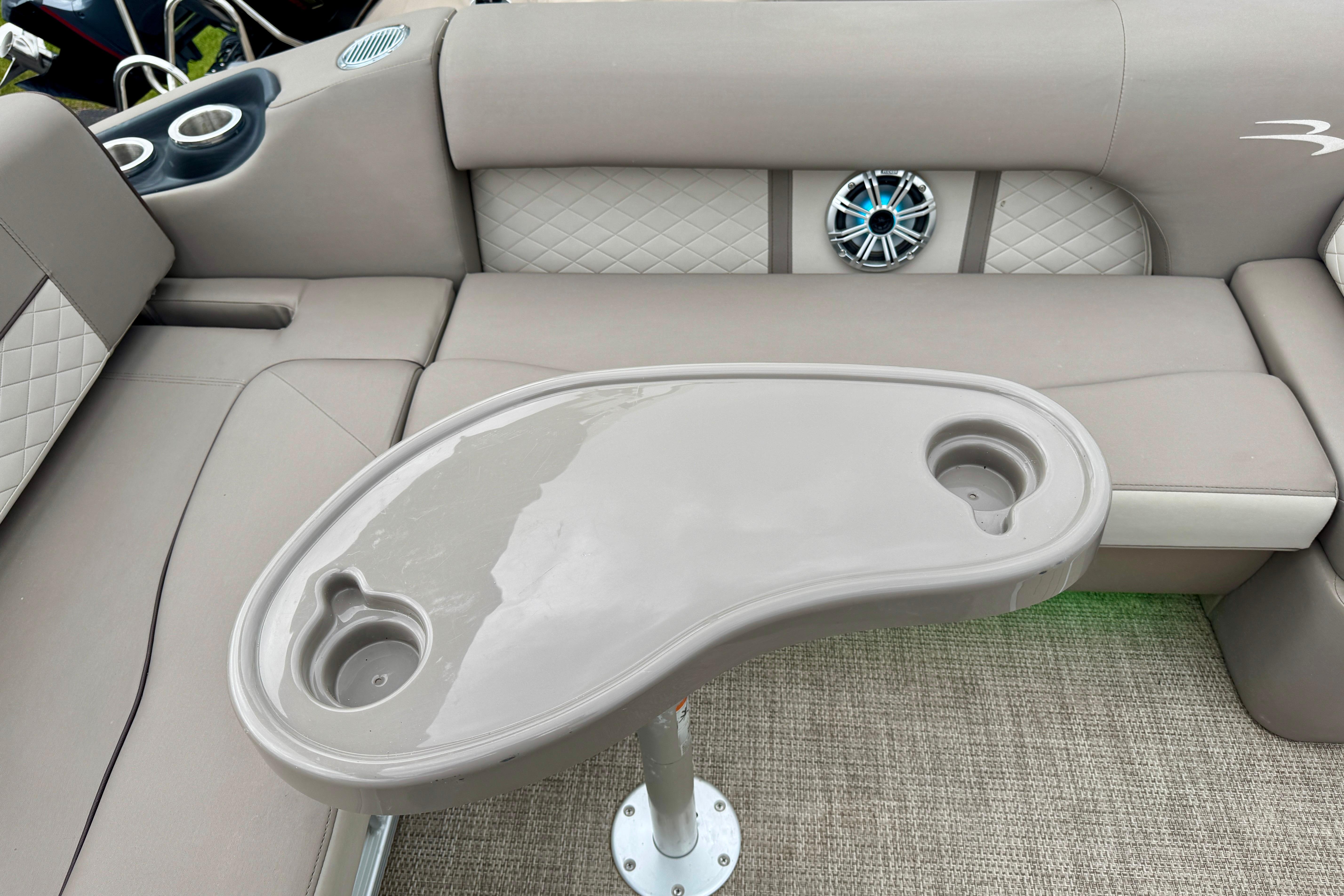 2019 Bennington SX 22 SSBXP boat interior with beige seating, cup holders, and speaker.