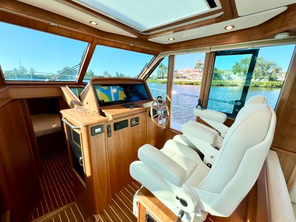 Luxurious interior of 2025 Sabre 43 Salon Express yacht with modern helm and panoramic windows.