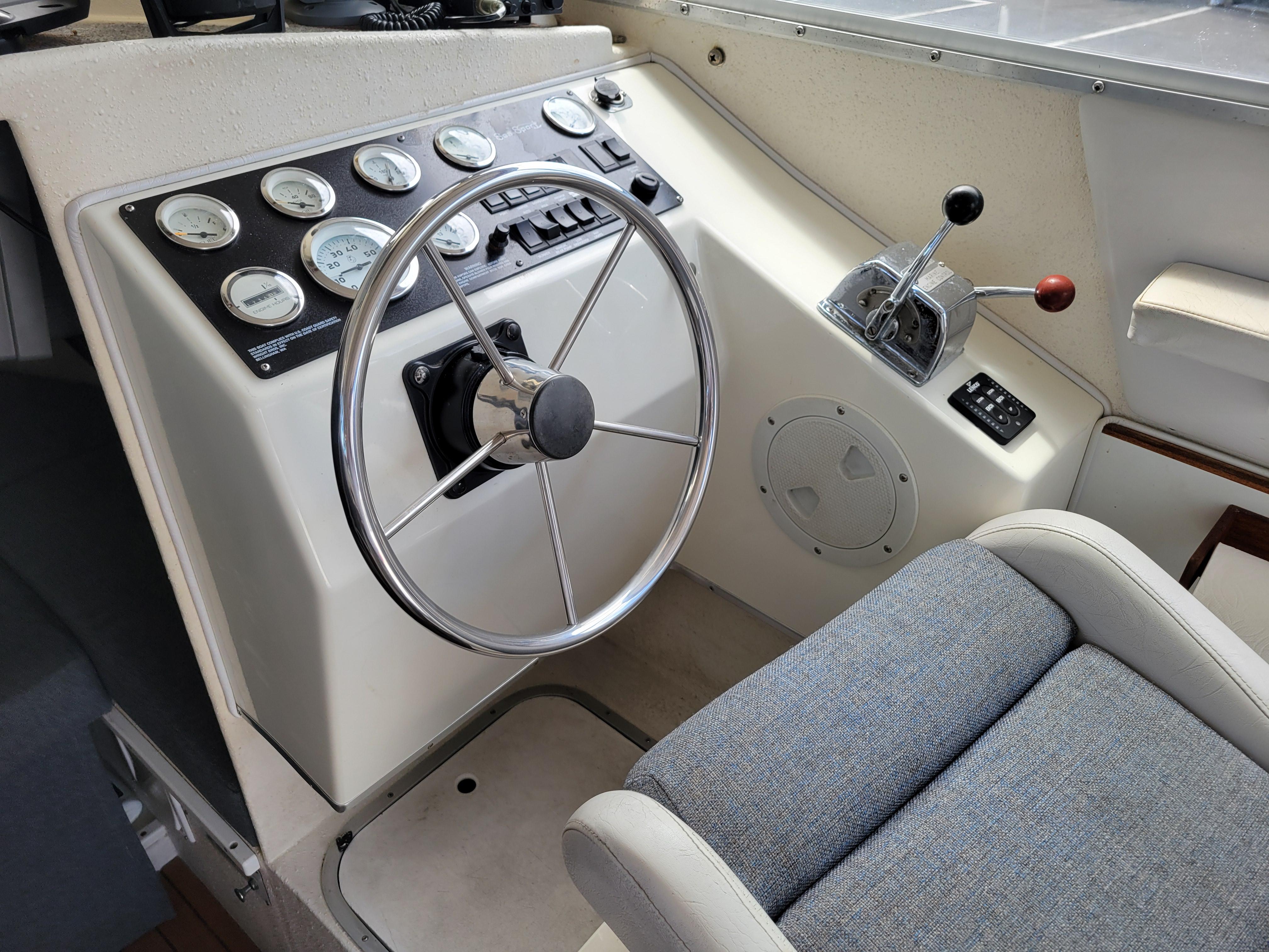 1999 SeaSport 2400 XL Limited boat cockpit with steering wheel and control panel.