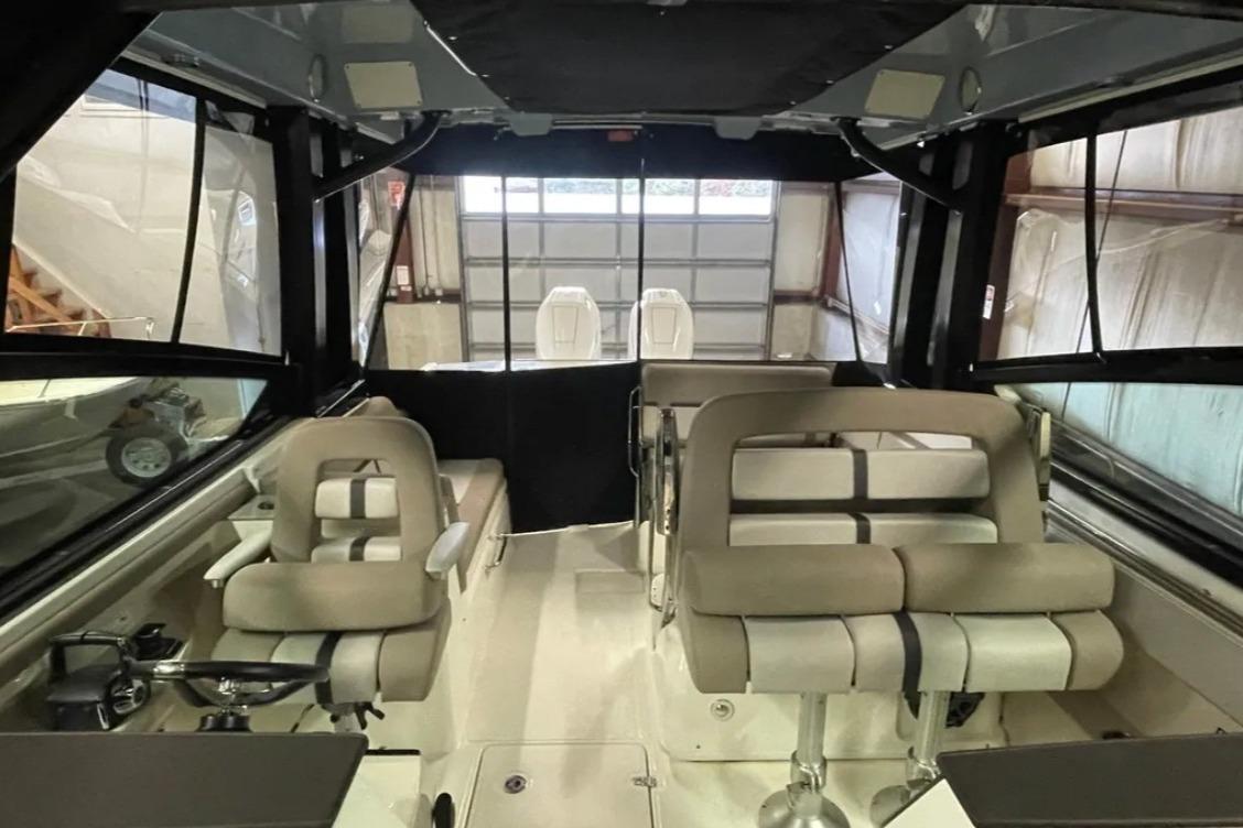 Interior view of 2025 Boston Whaler 330 Vantage boat with seating and helm.