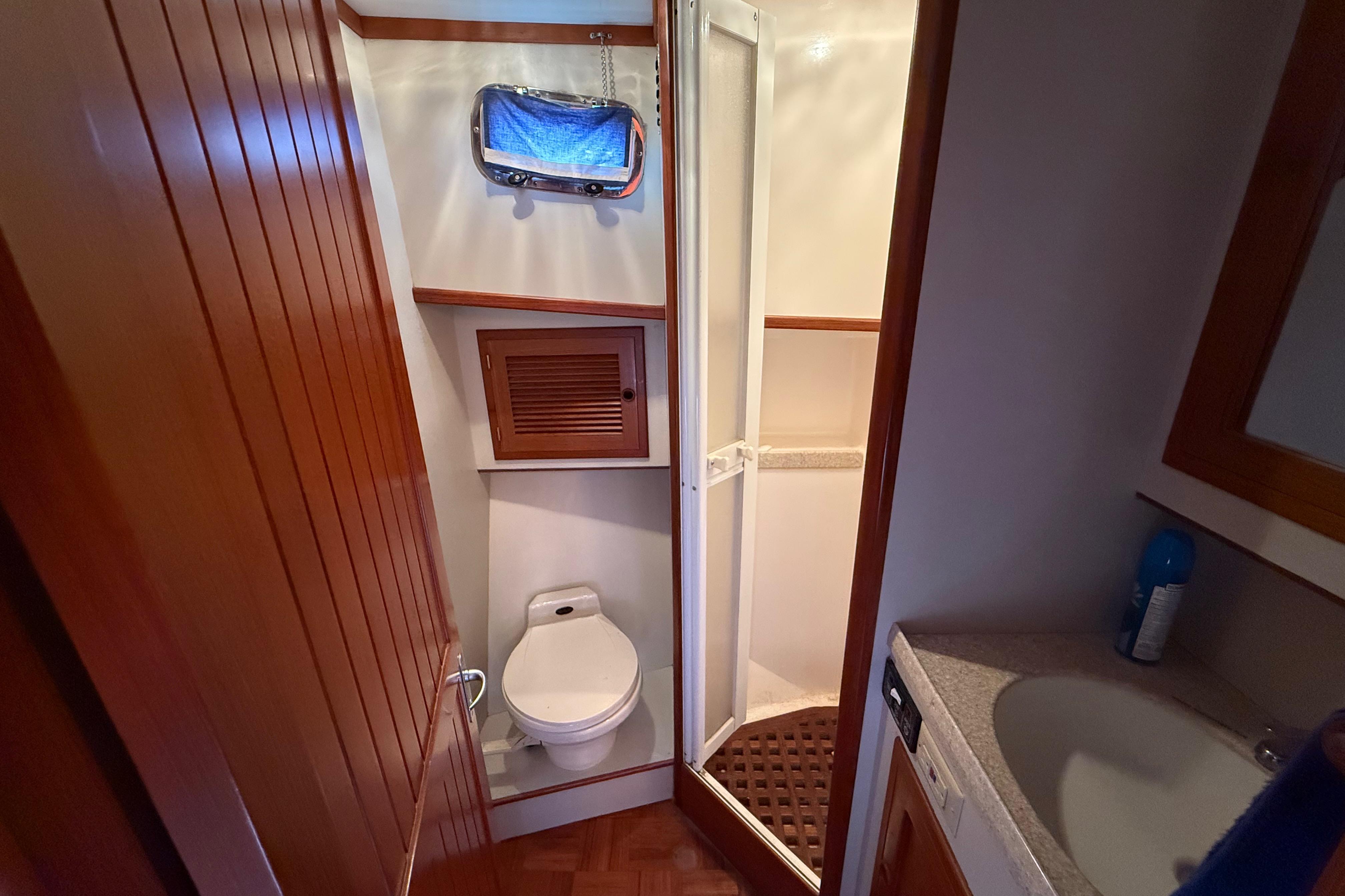 Bathroom interior of 2001 Kadey-Krogen 39 yacht with shower, toilet, and sink.