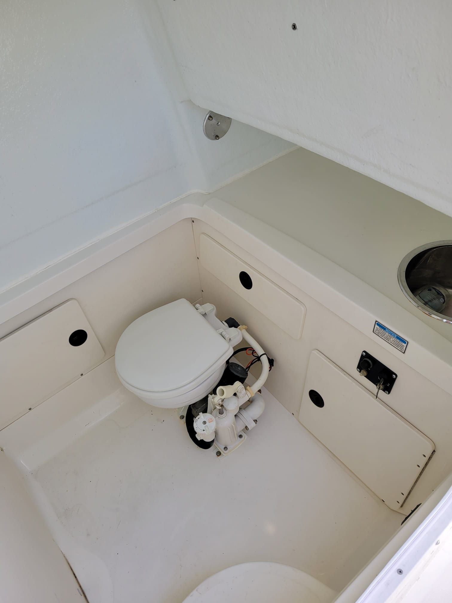 Interior of a 2001 Boston Whaler 26 Outrage with toilet and sink.