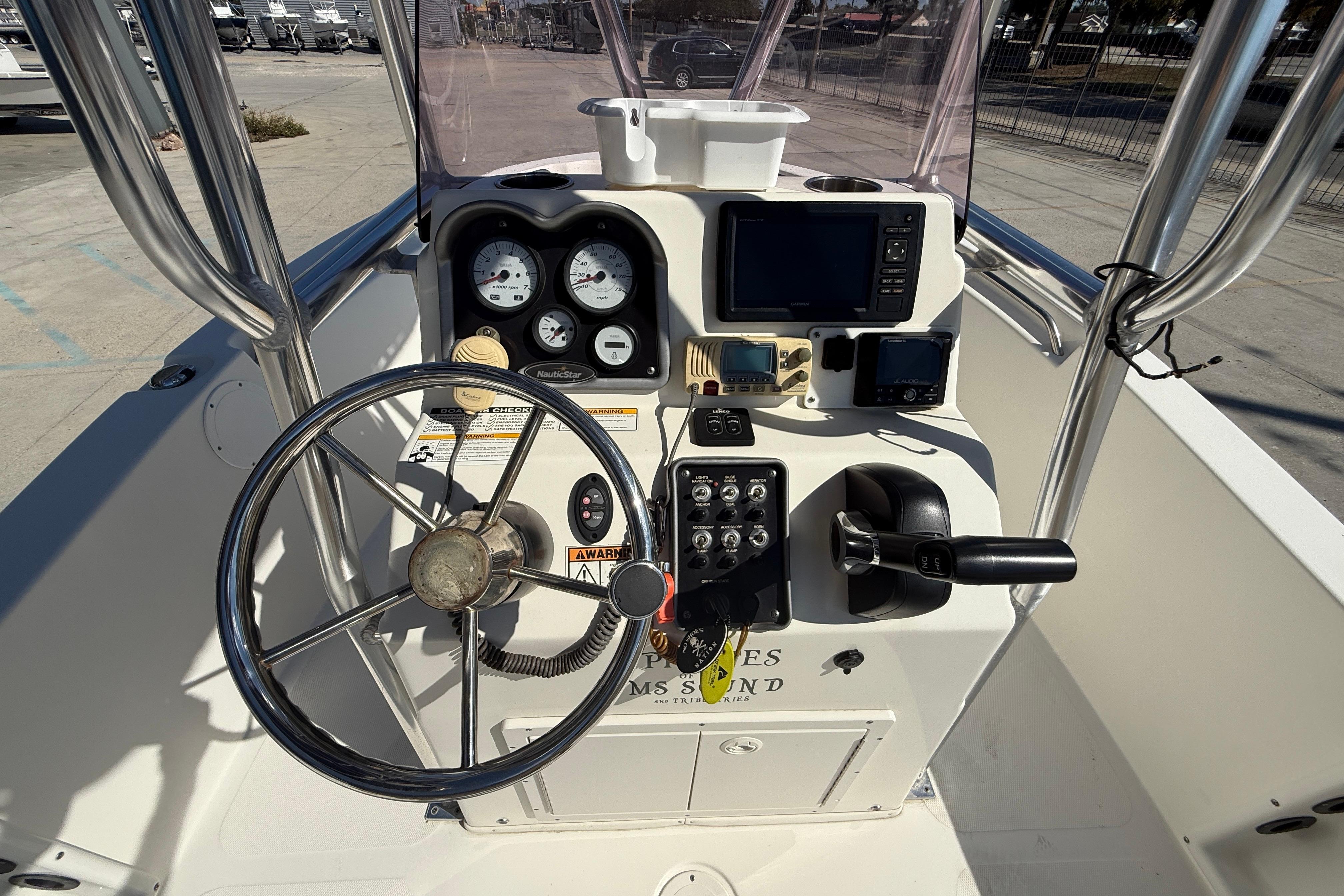 2019 NauticStar 19 XS boat console with steering wheel and navigation instruments.