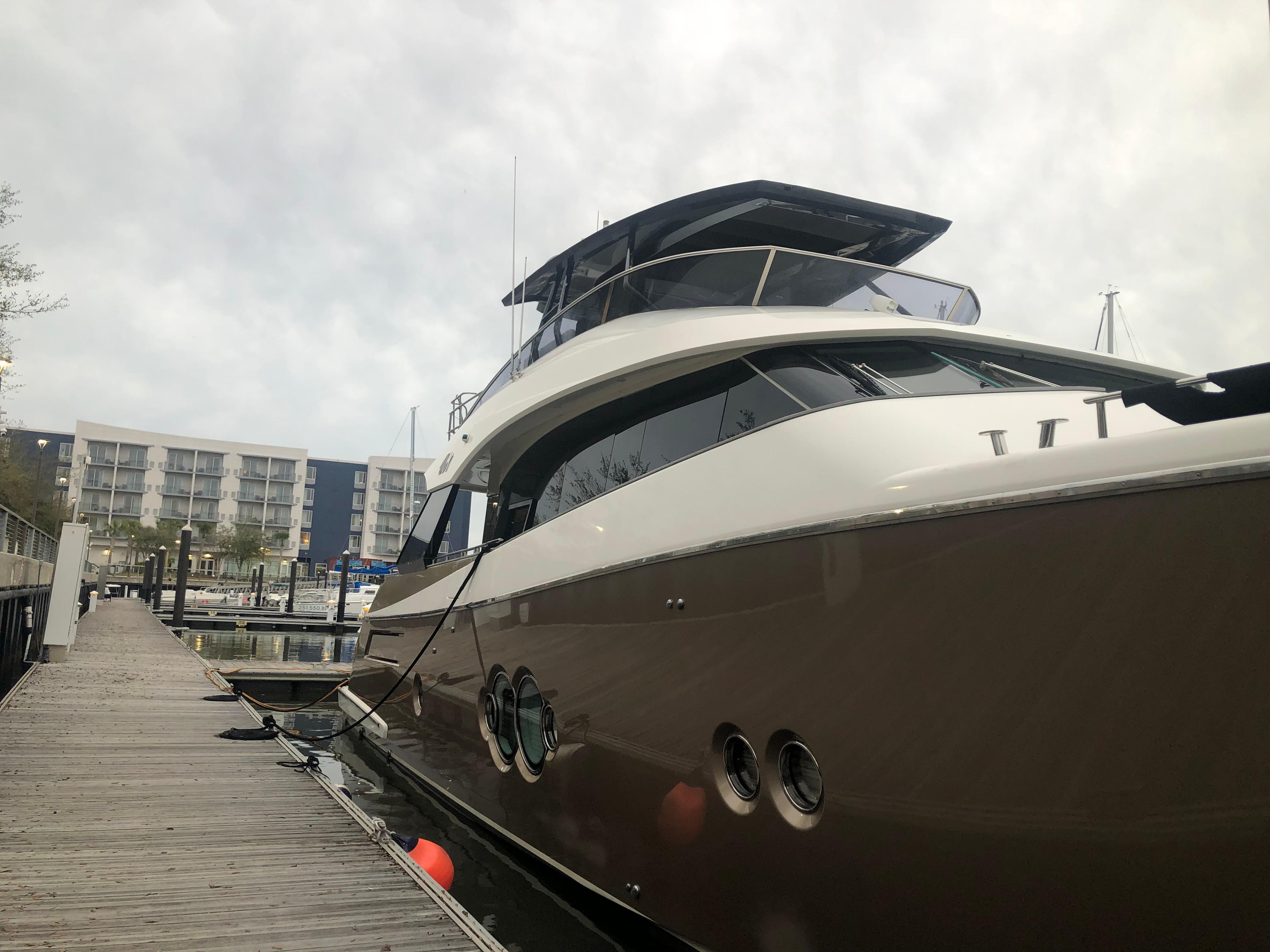 2012 Monte Carlo Yachts 76 docked at a marina.