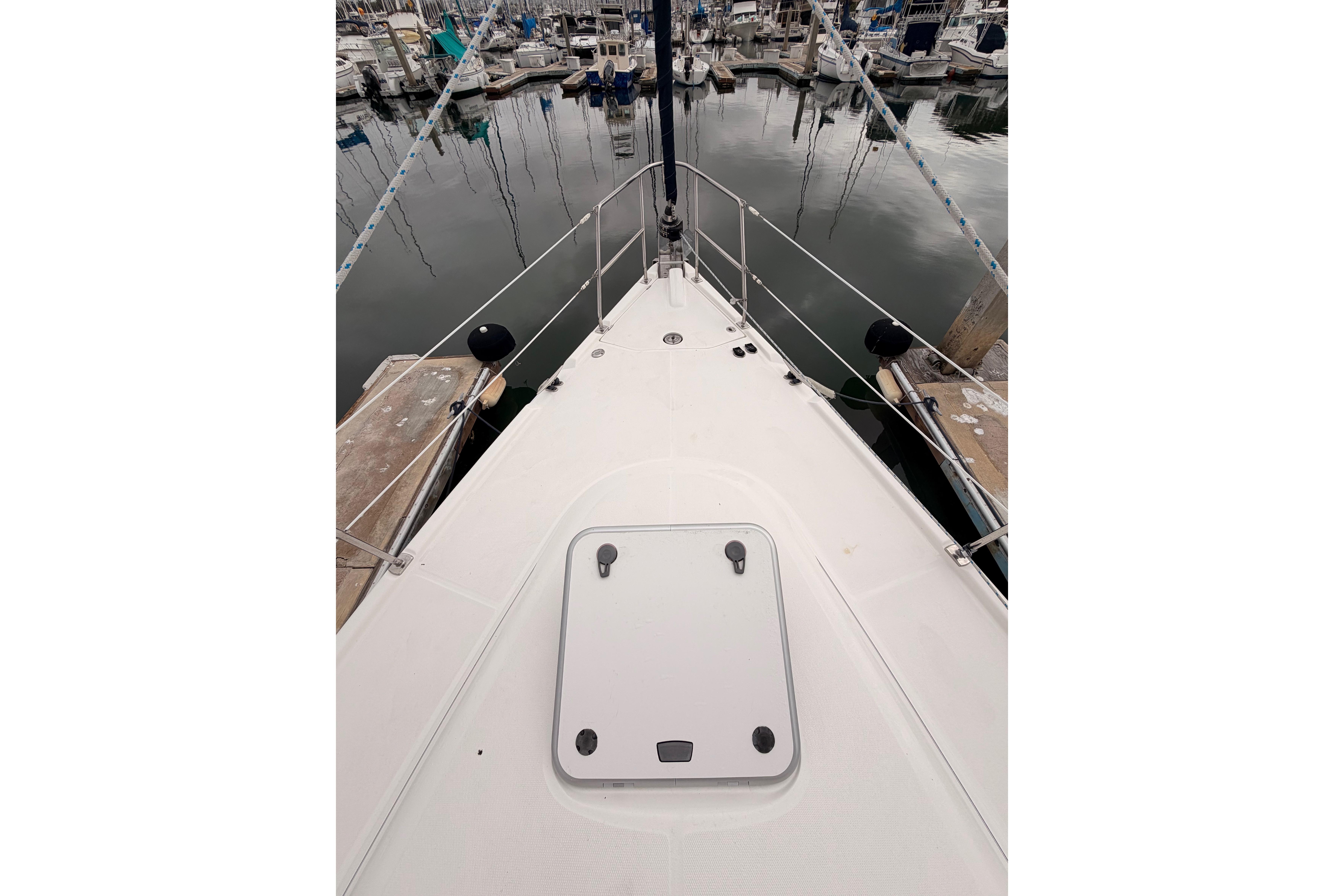 Bow view of 2009 Hunter 38 sailboat docked in marina.