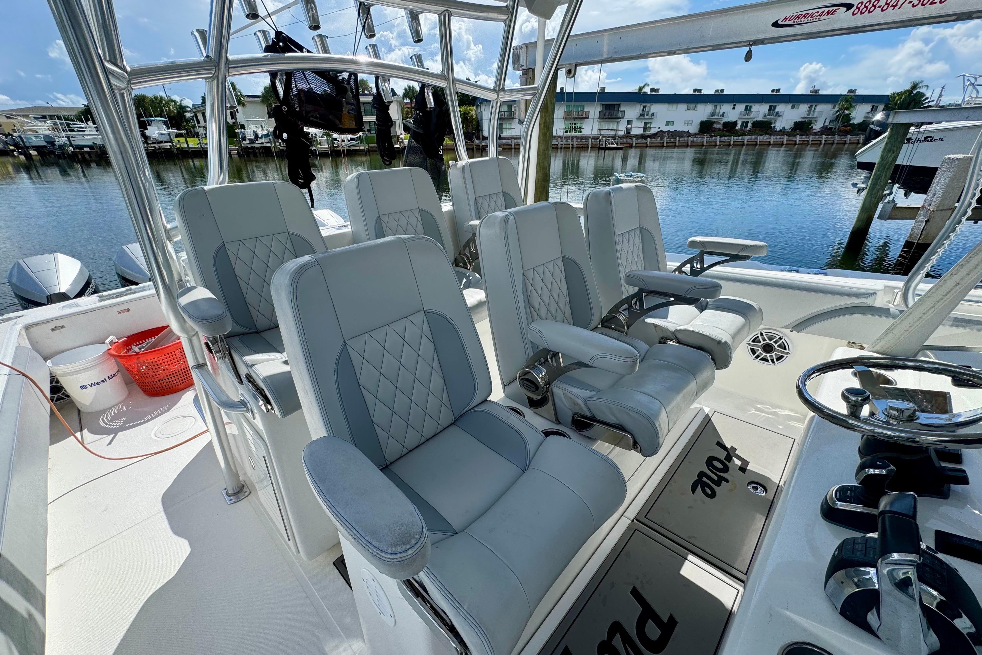 2021 SeaHunter 41 CTS boat interior with luxurious seating and modern controls, docked by the water.